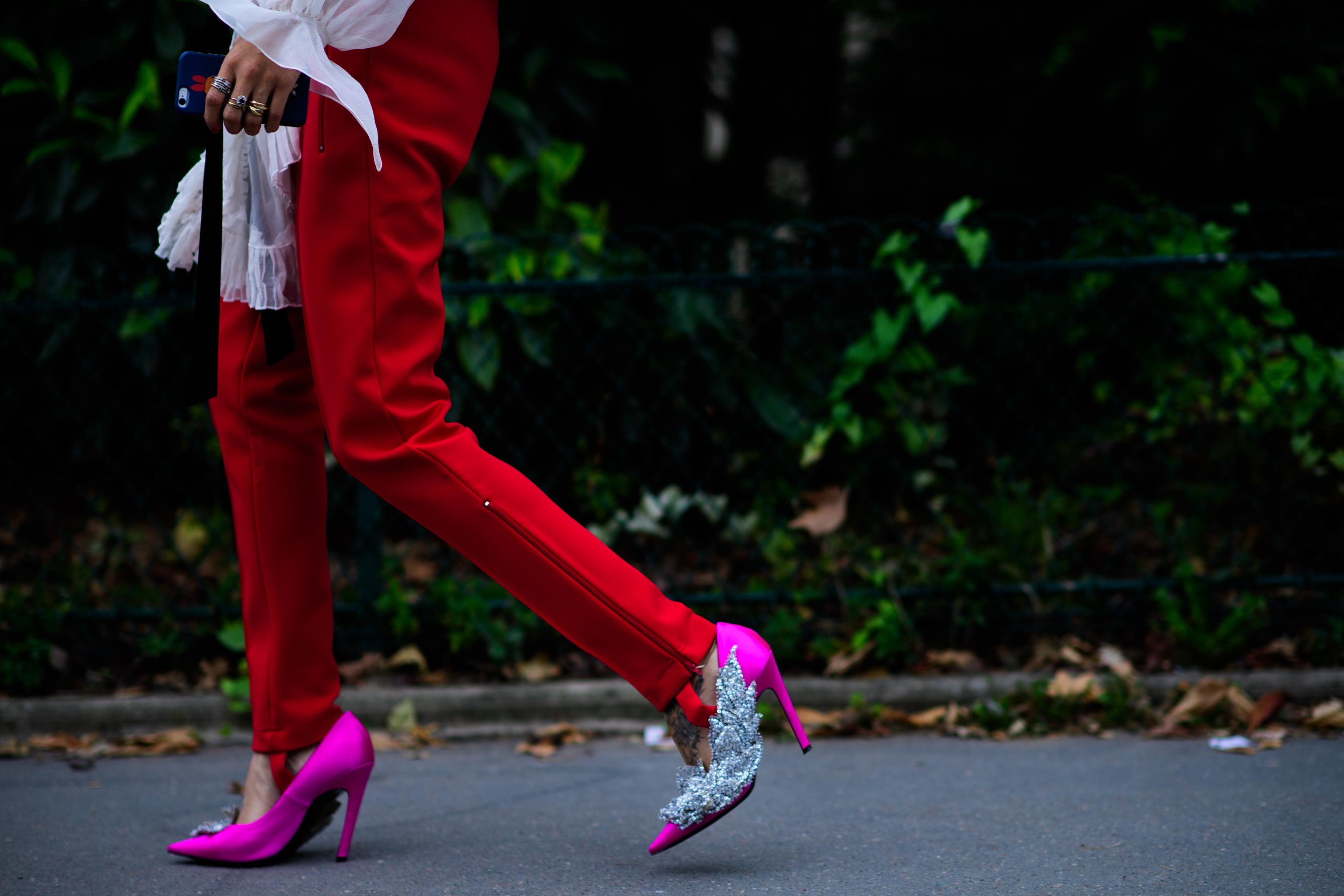 Woman wearing red pants pink shoes