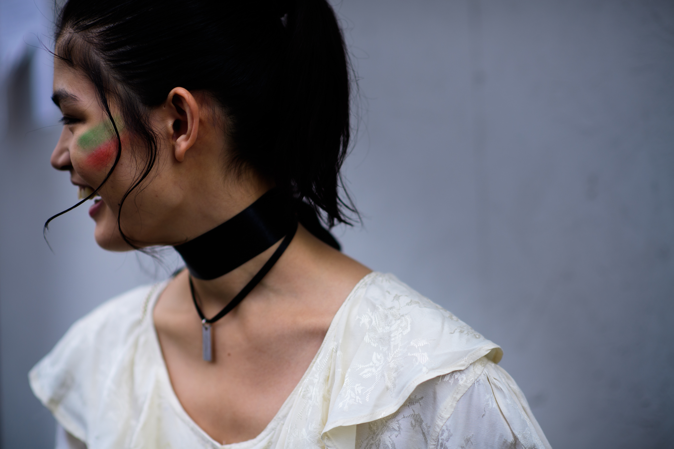Model wearing black bow on neck