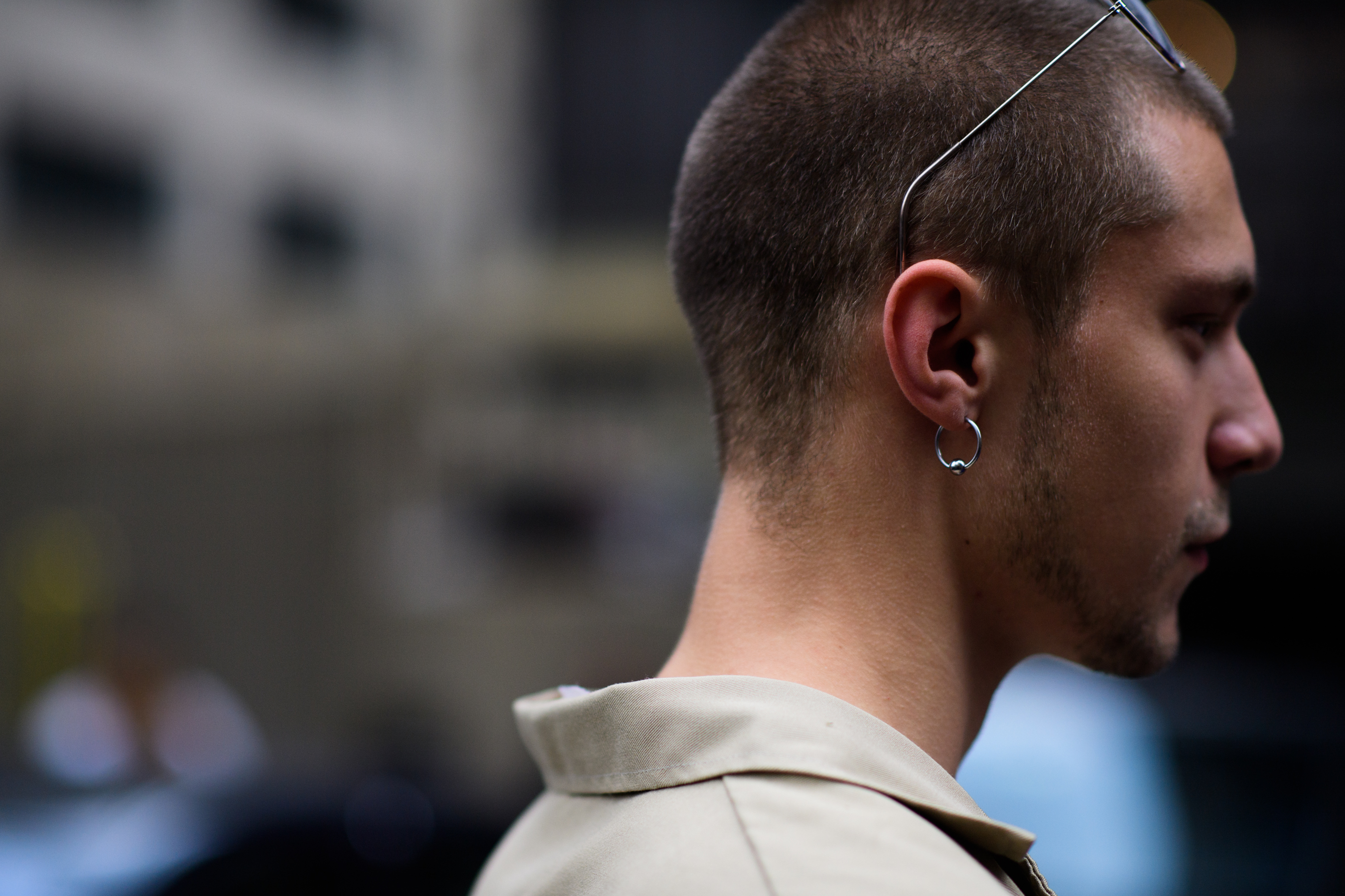 Man with shaved head wearing earring