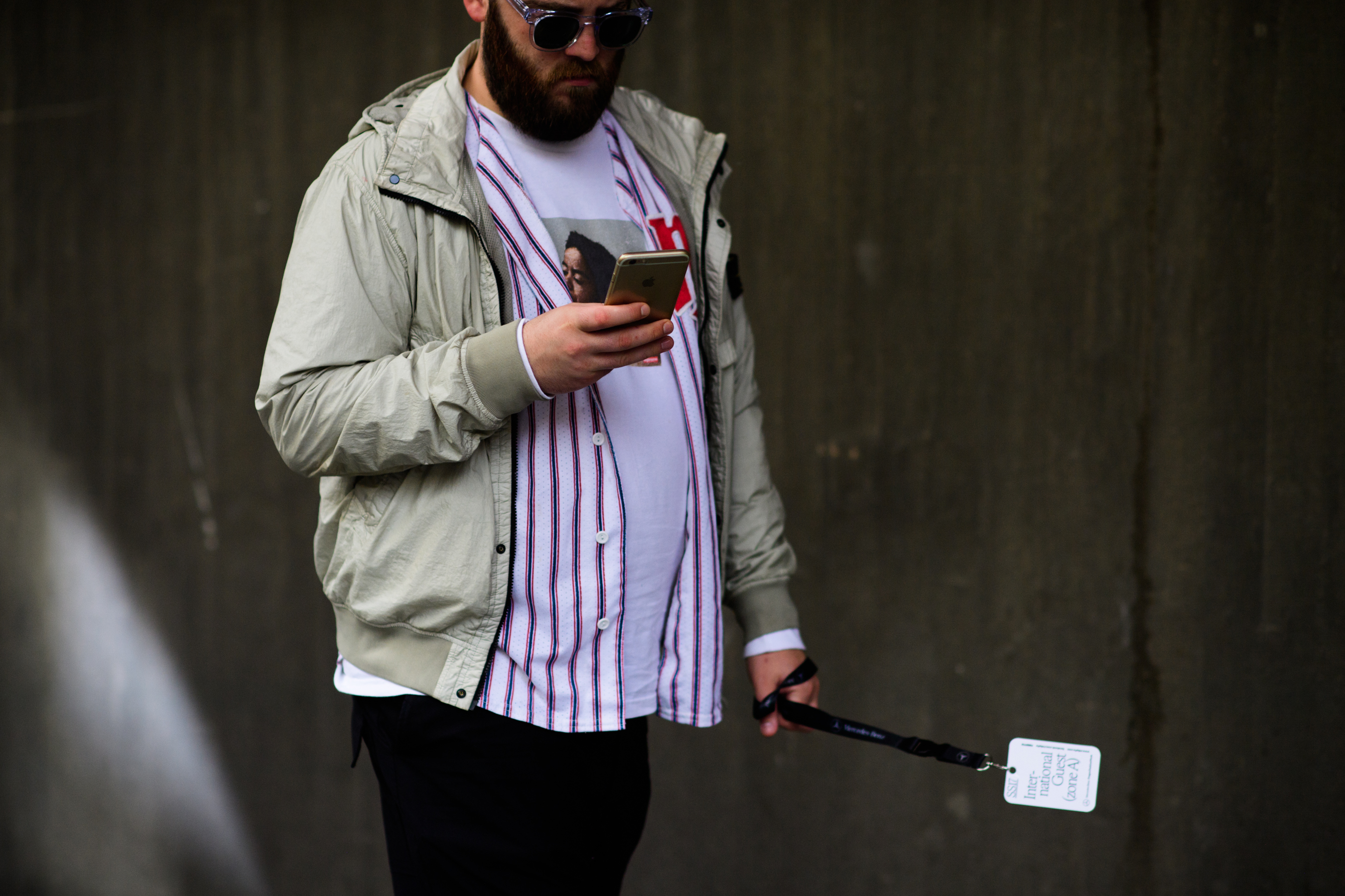 Man wearing beige bomber and shirt
