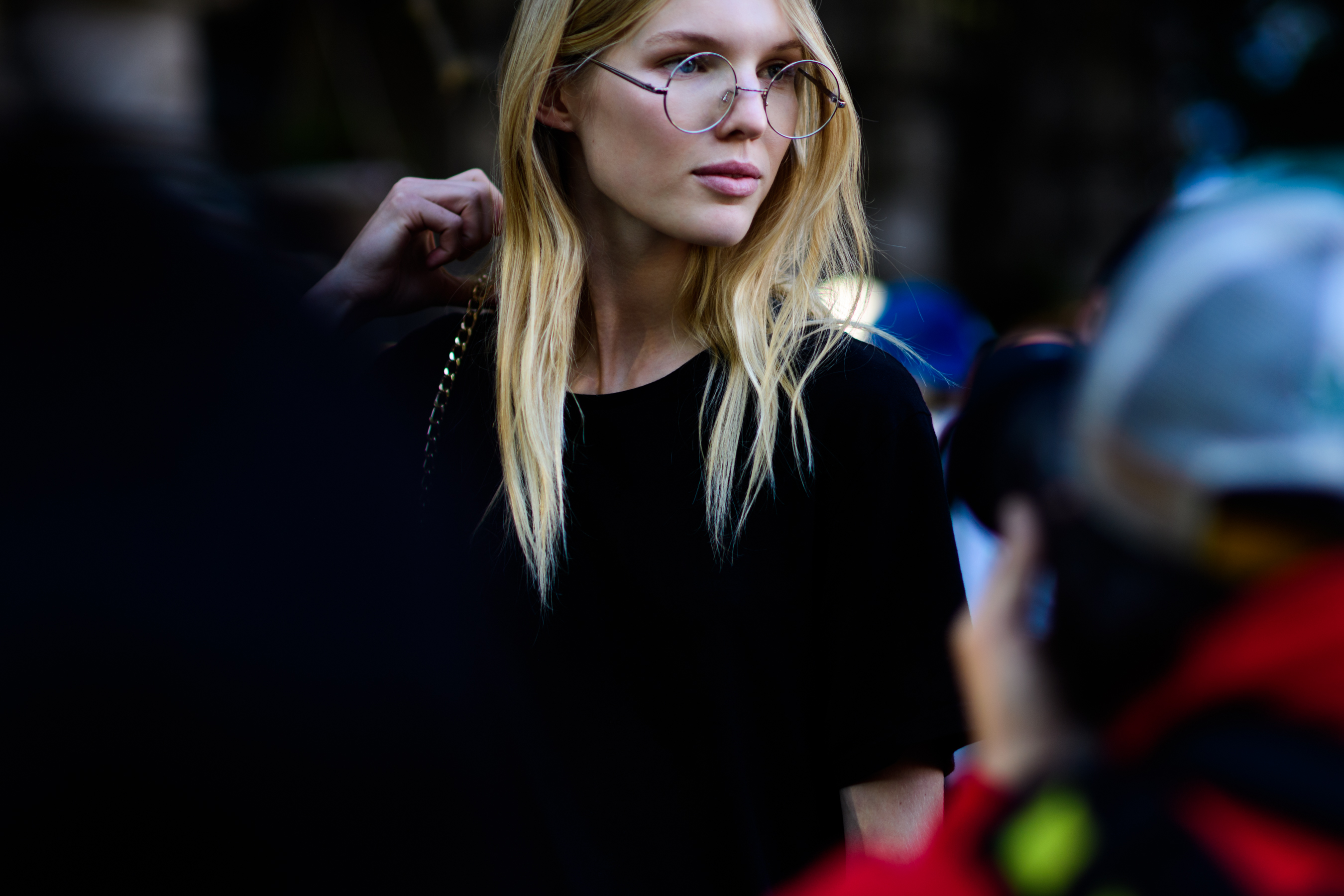 Model wearing rounded glasses