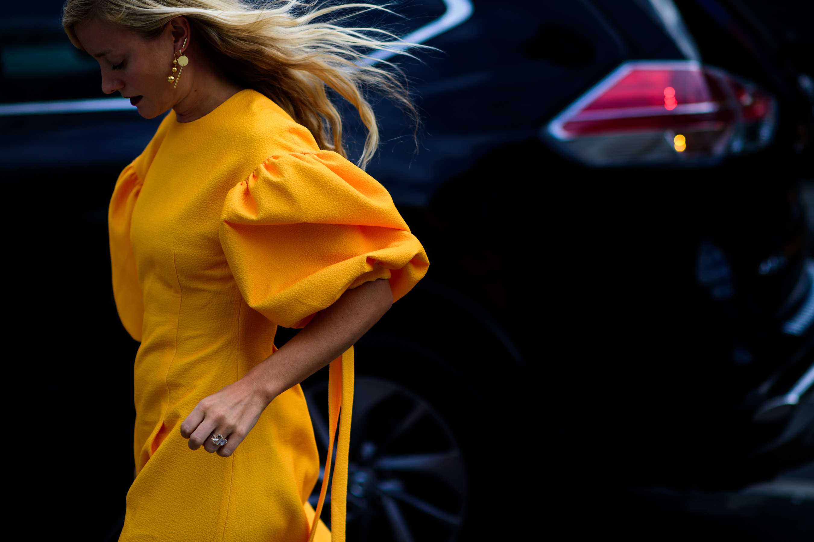 Editor wearing bright orange dress