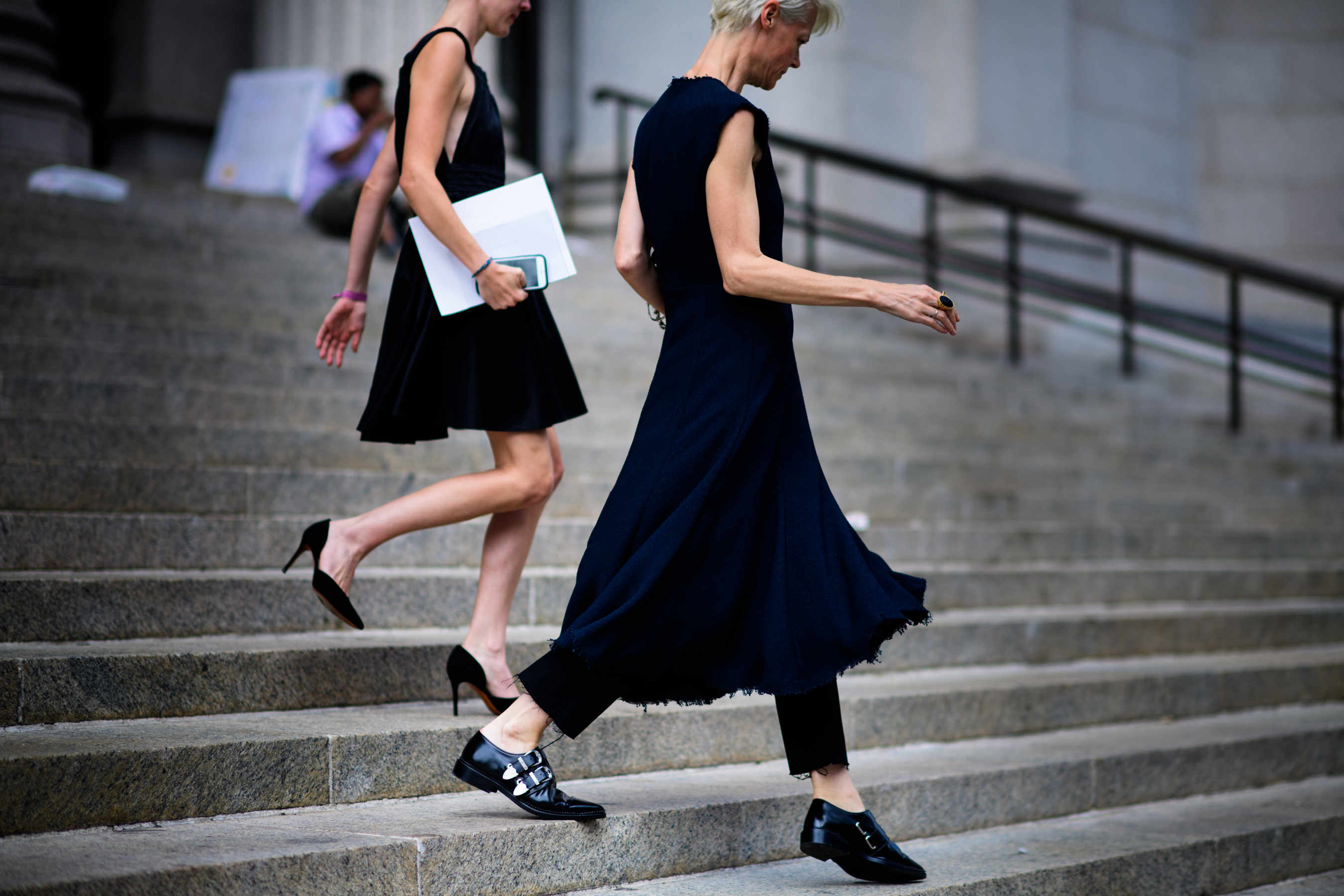 Two women walking down the stairs