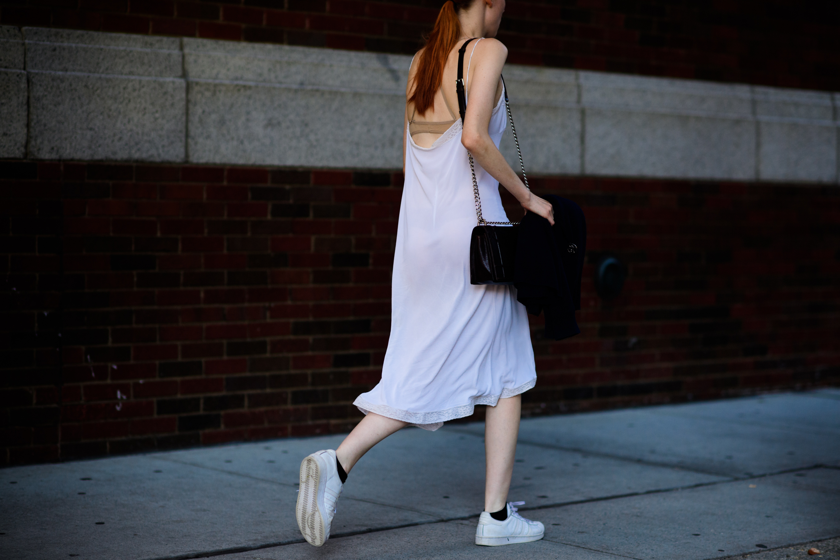 American model wearing white dress