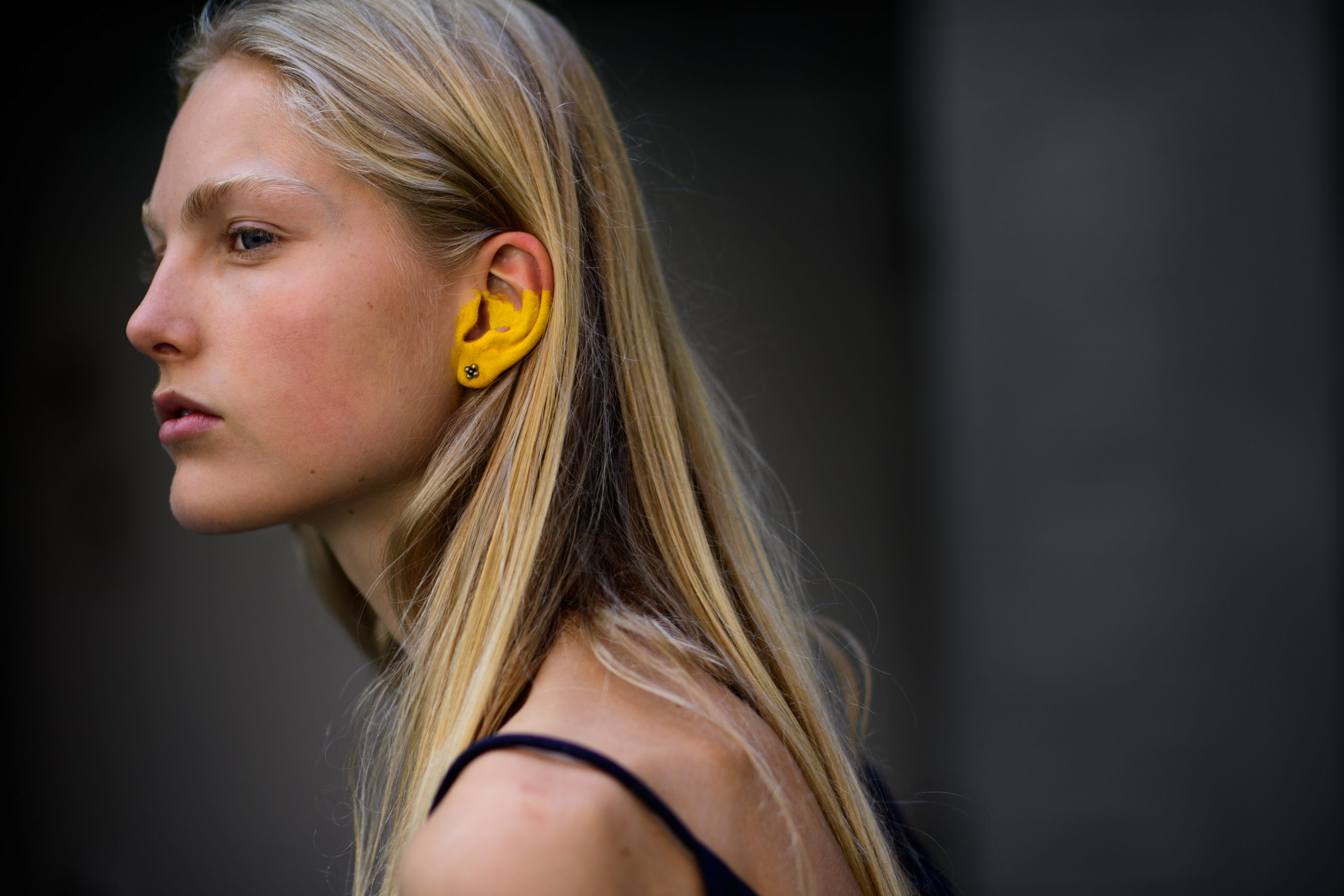 Model with yellow painted ear