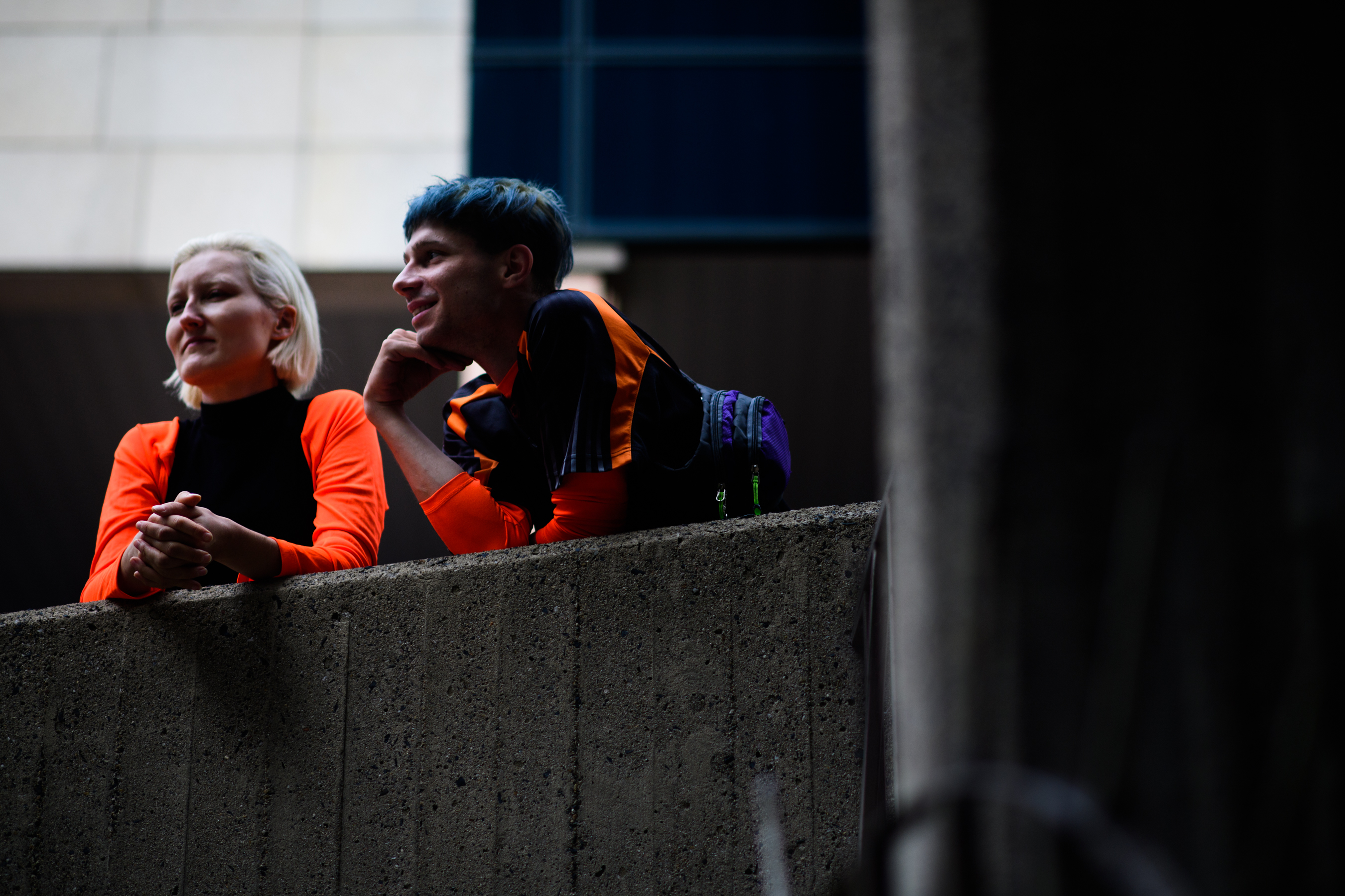Man and woman wearing bright orange