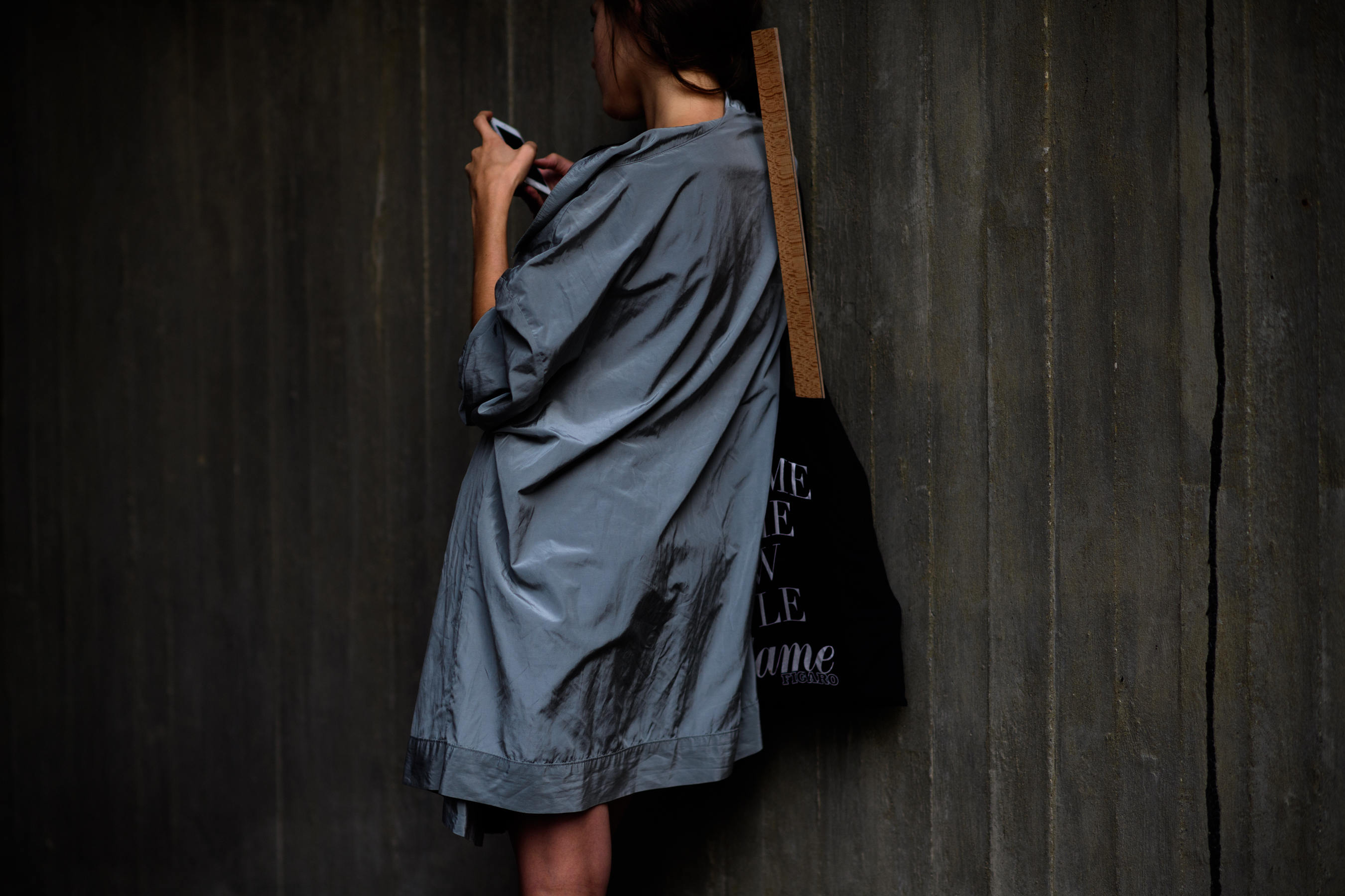 Woman wearing gray shiny jacket
