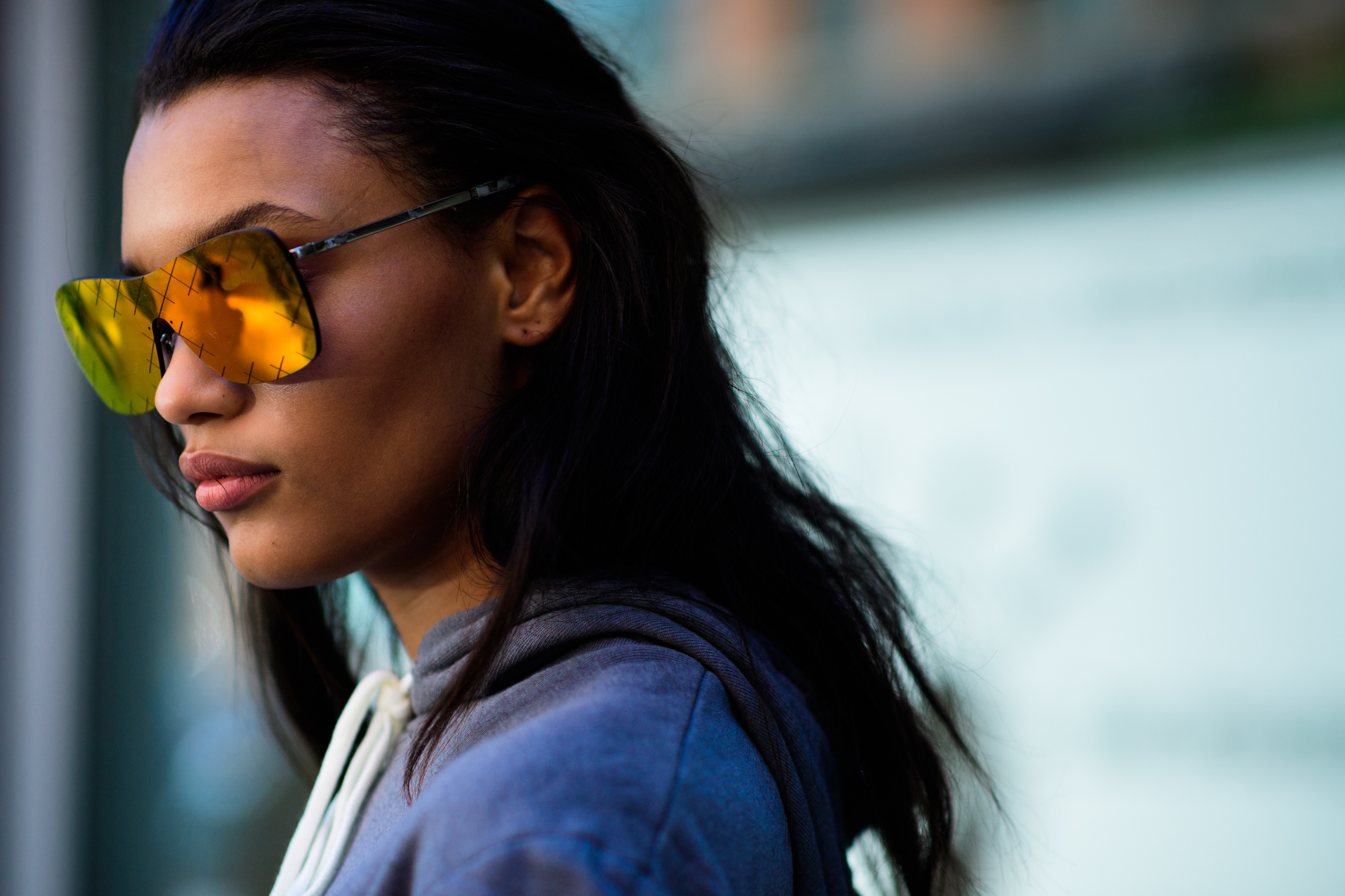 Model wearing yellow reflective glasses