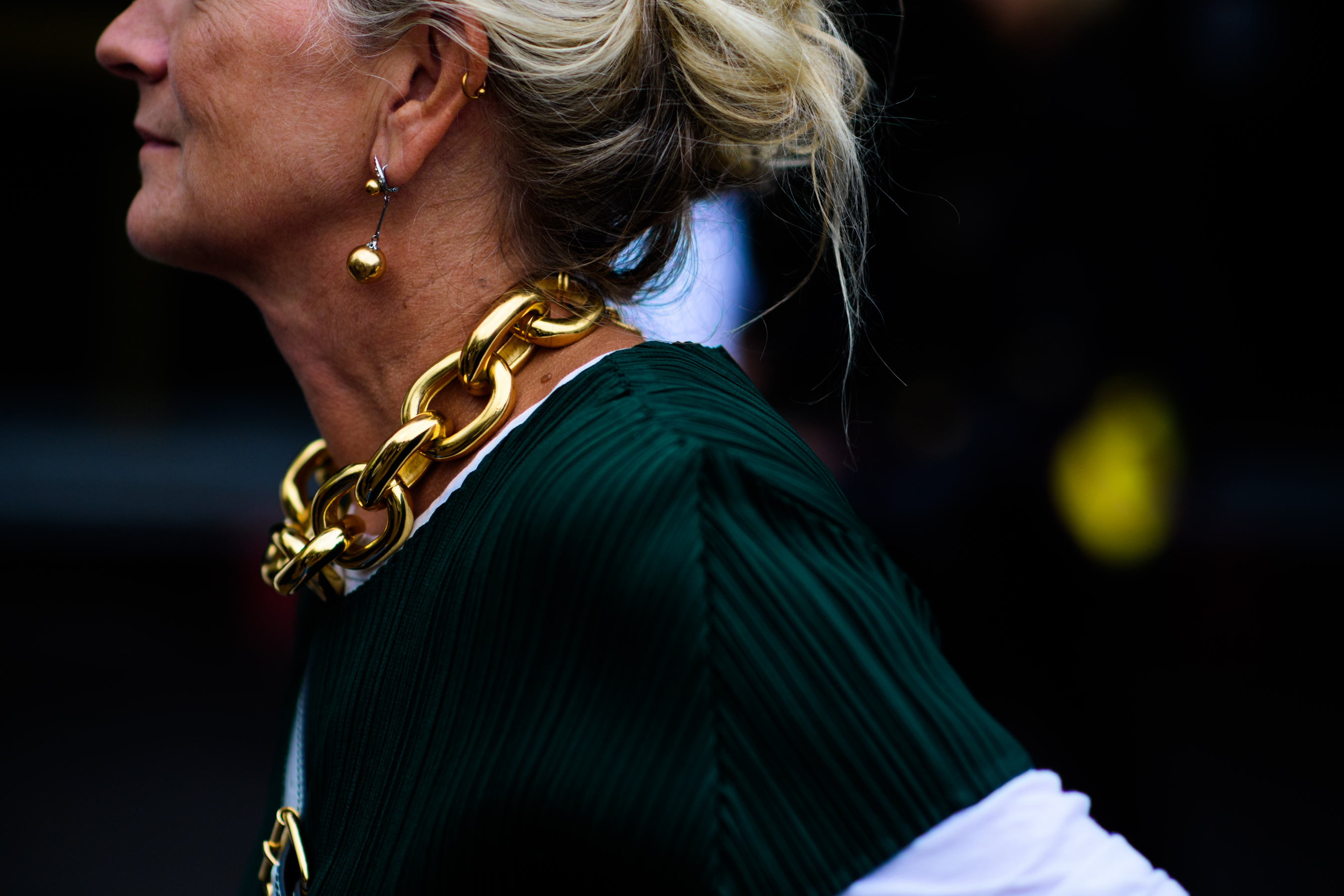 Woman wearing chunky golden jewellery