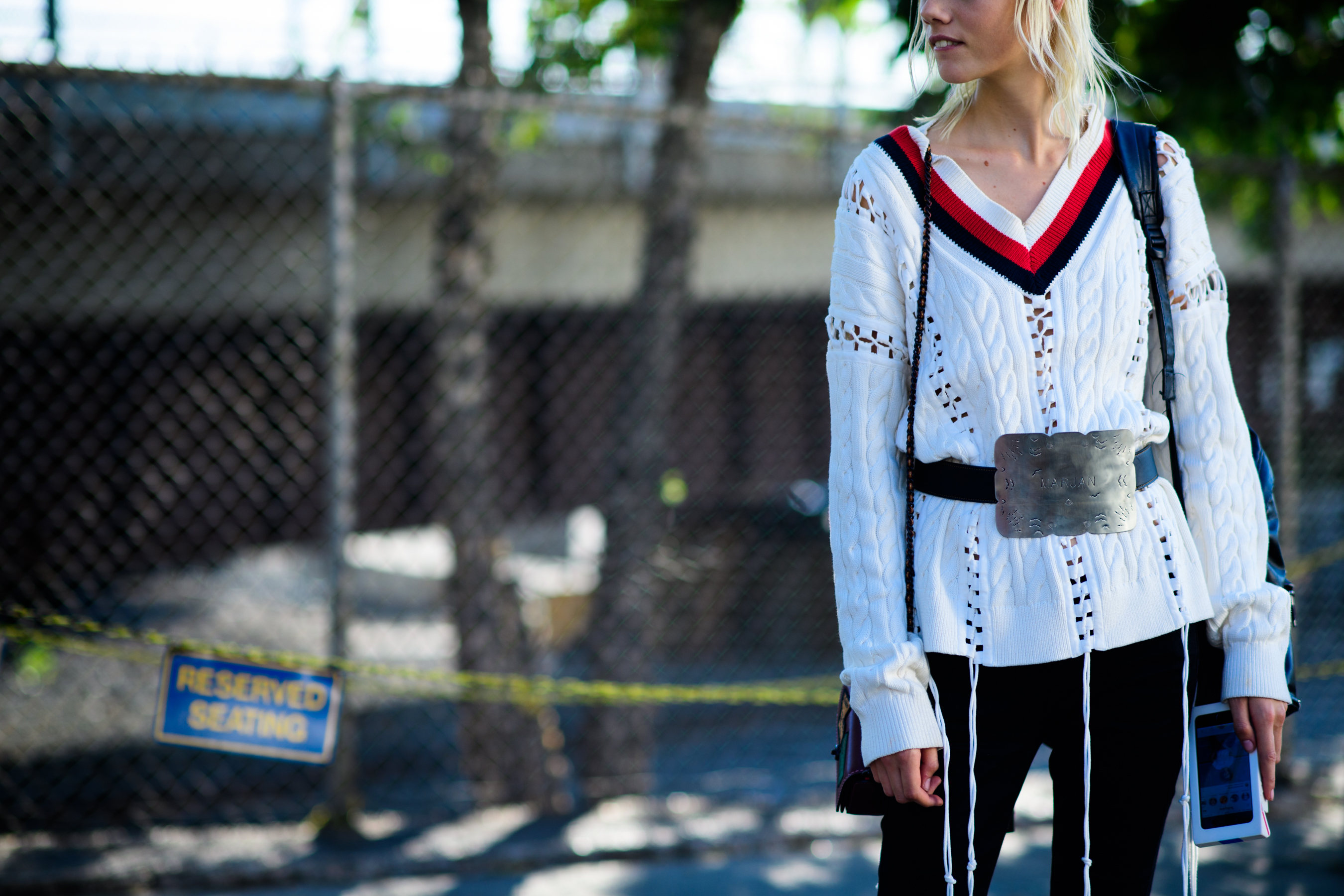 Model wearing white belted sweater