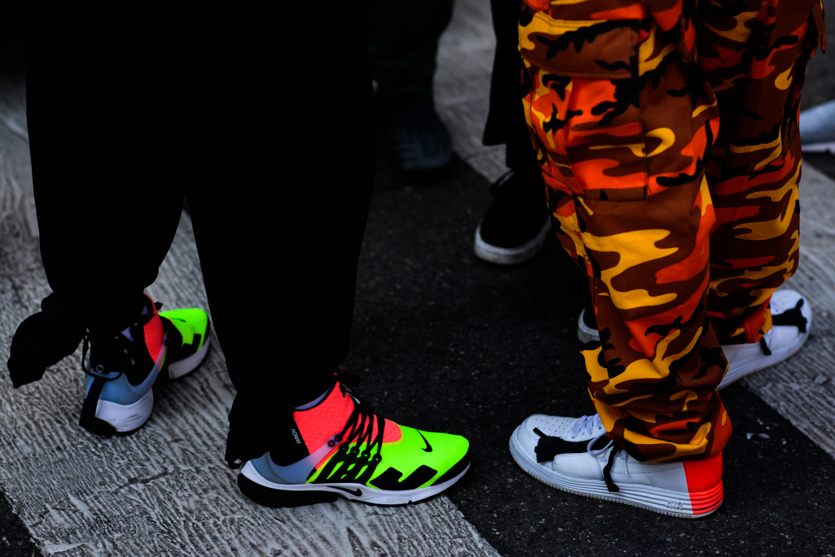 Two photographers wearing Nike x Acronym sneakers