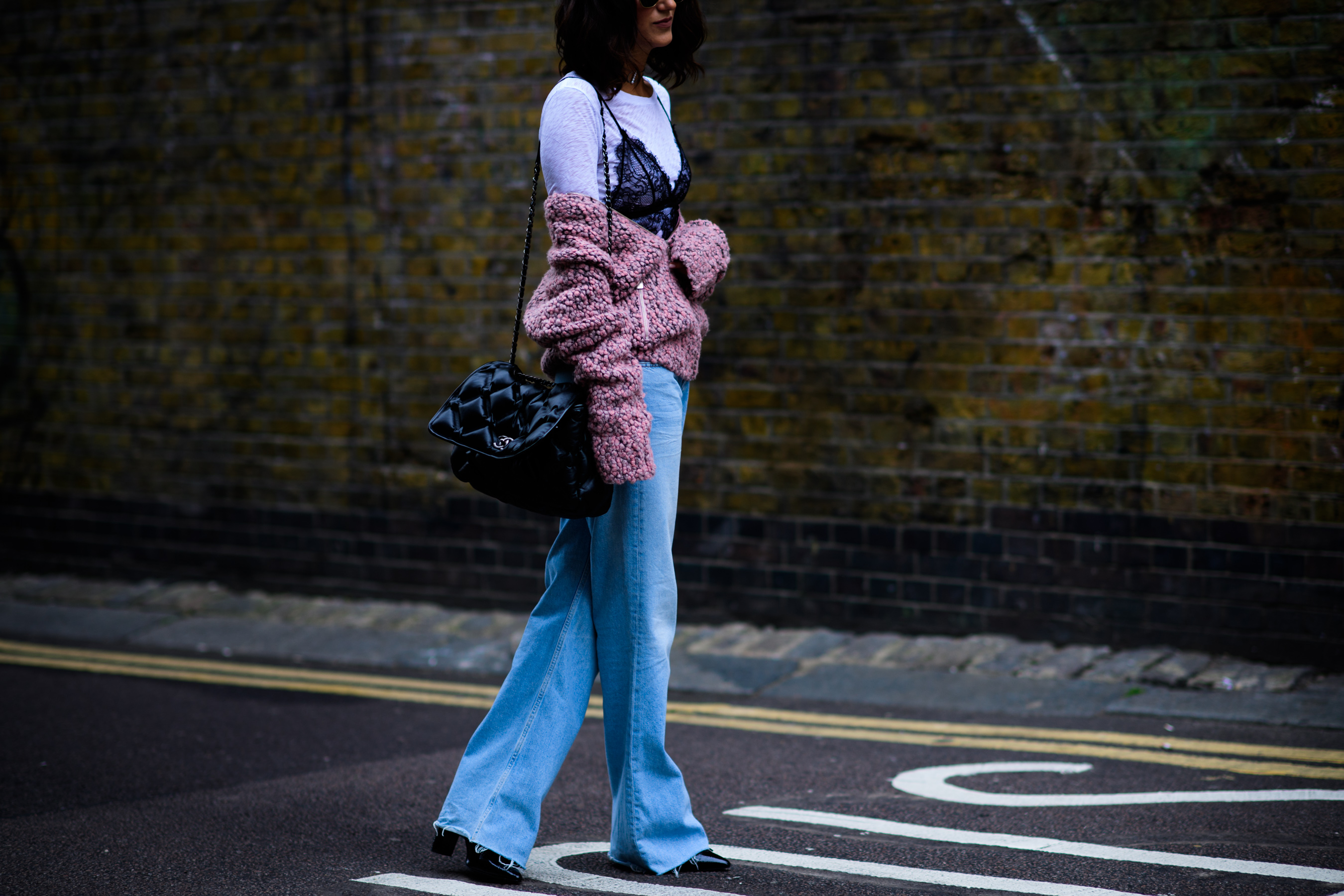 Woman wearing pink cardigan and denim
