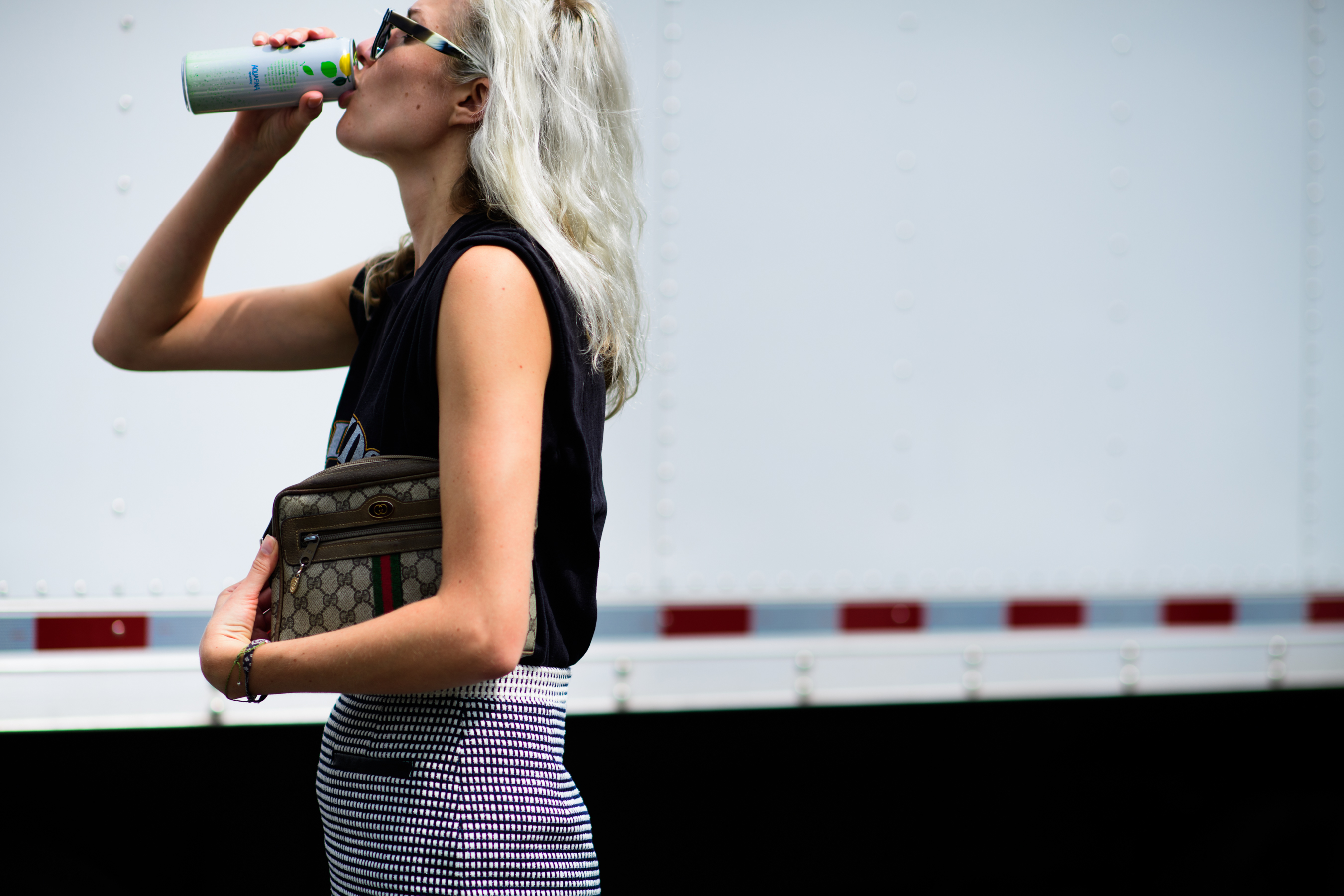 Woman holding Gucci clutch bag