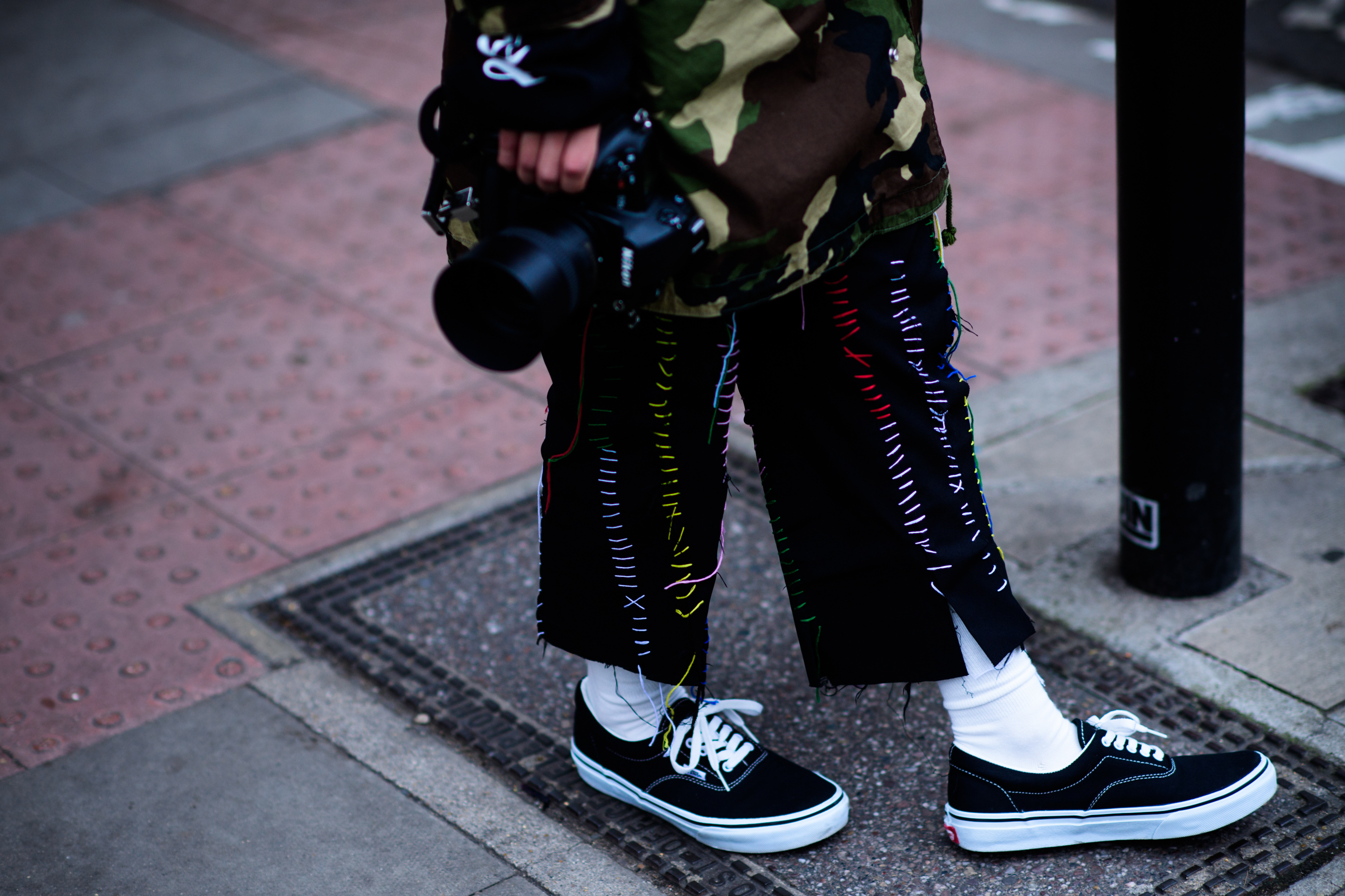 Japanese photographer wearing stitched pants