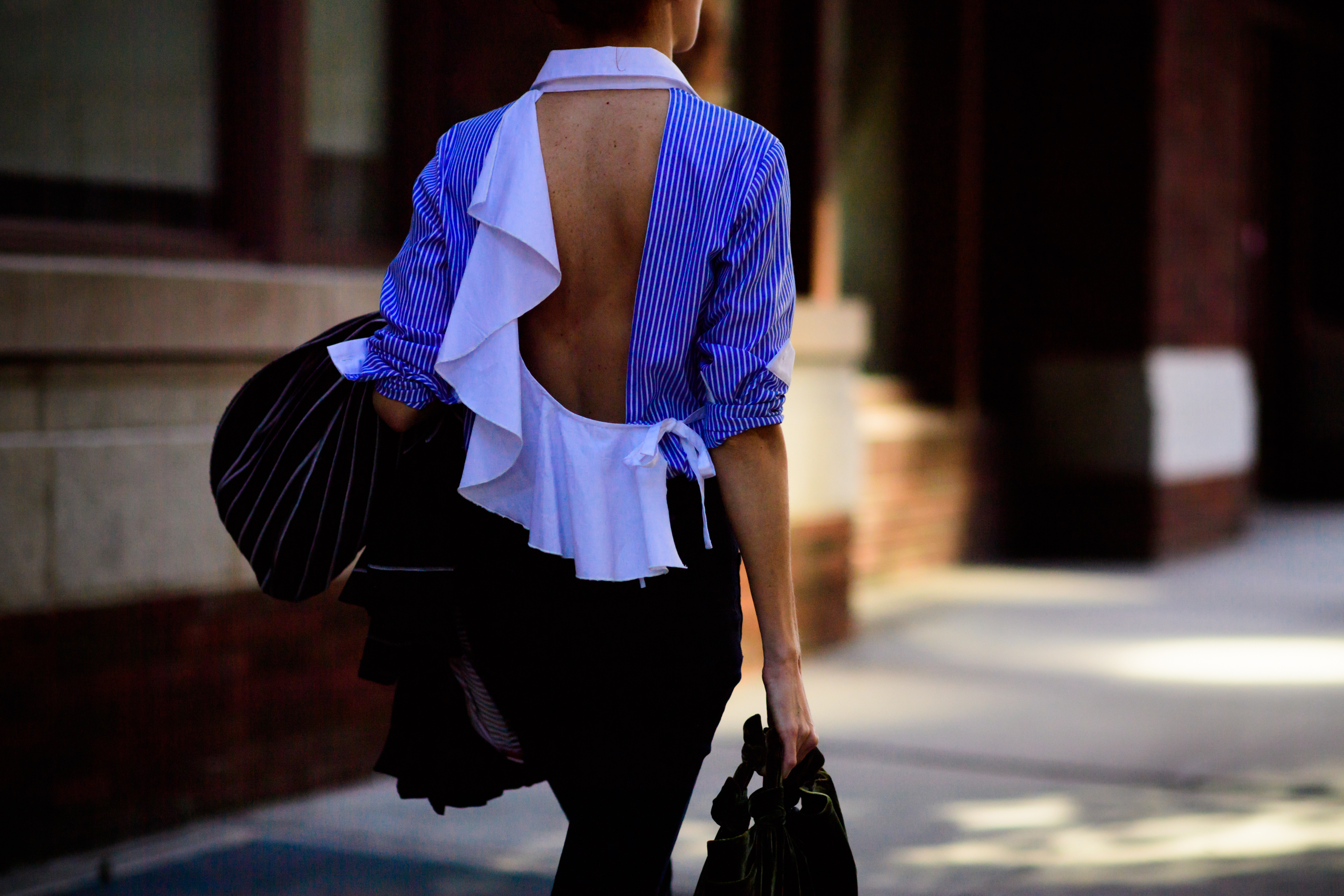 Woman wearing open back shirt