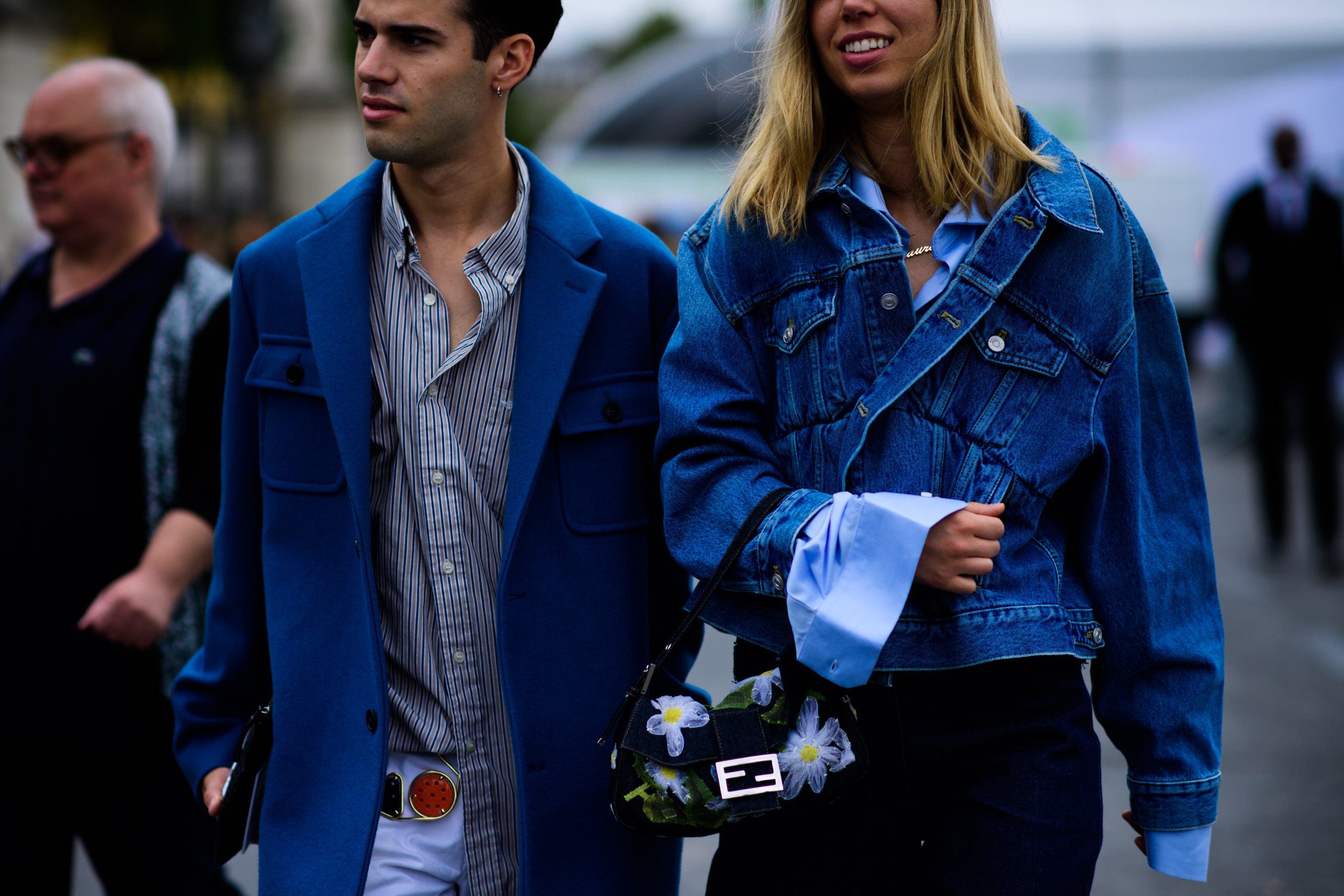 Man and woman wearing blue outfits