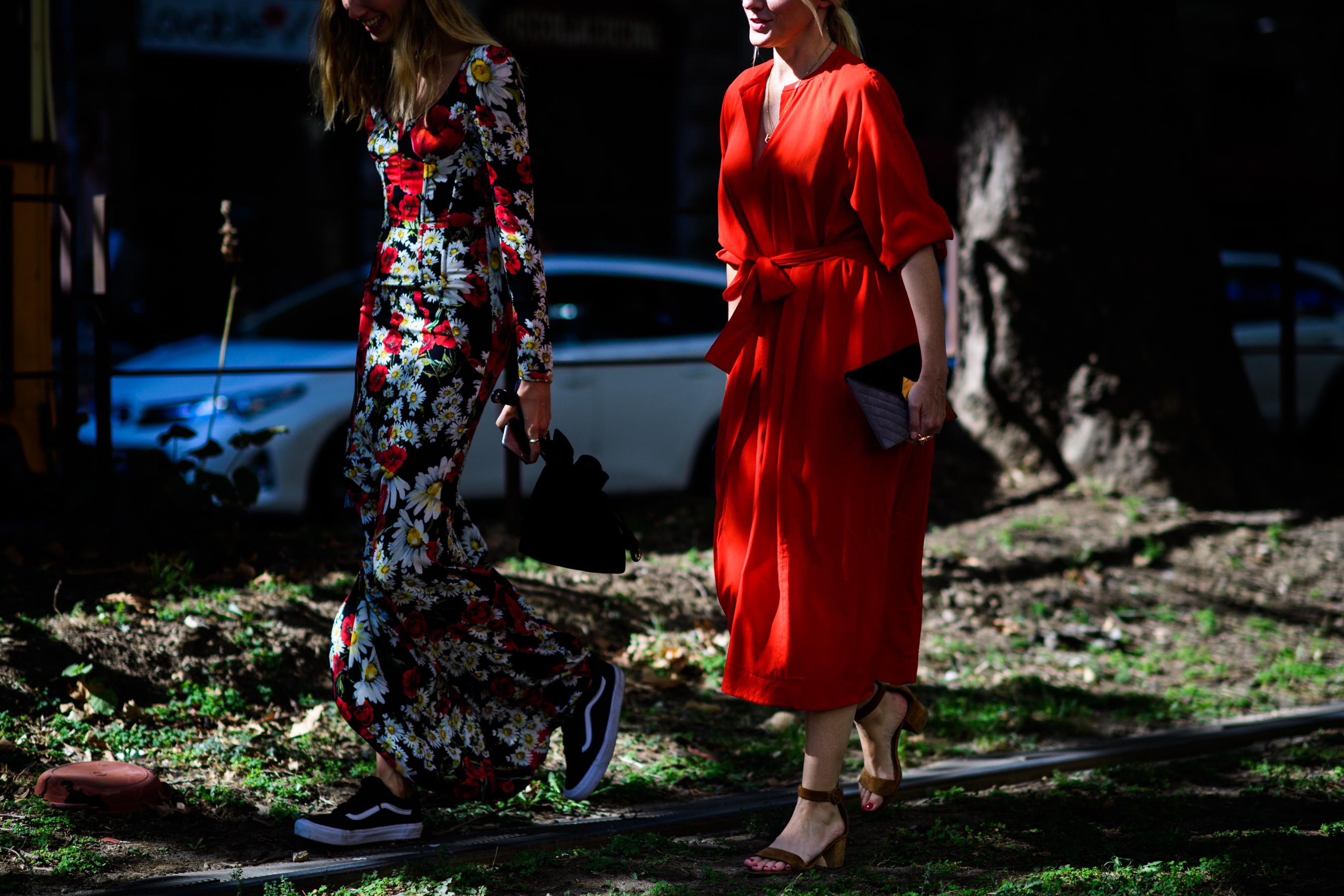 Two women wearing red dresses