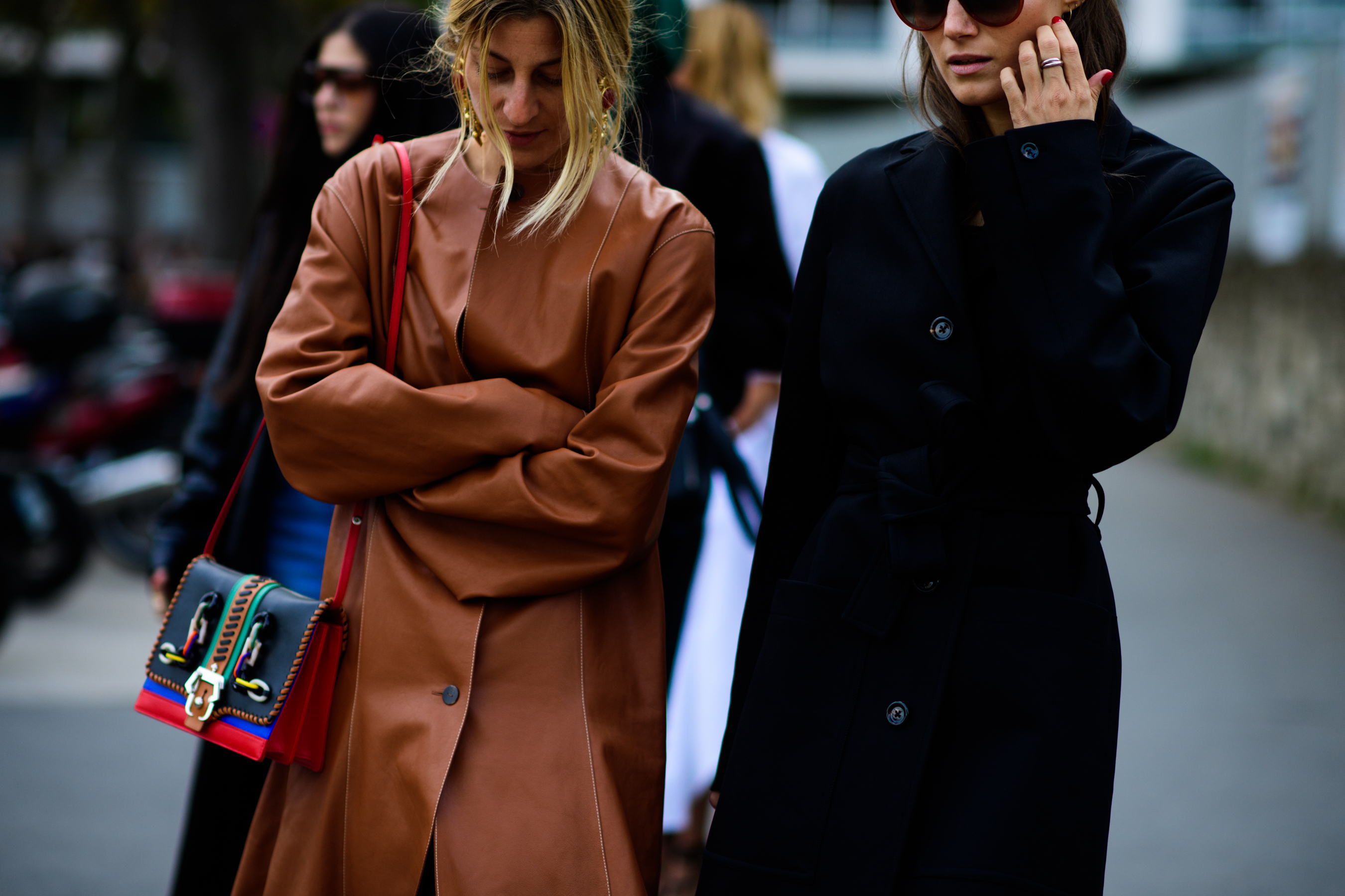 Two women wearing long coats