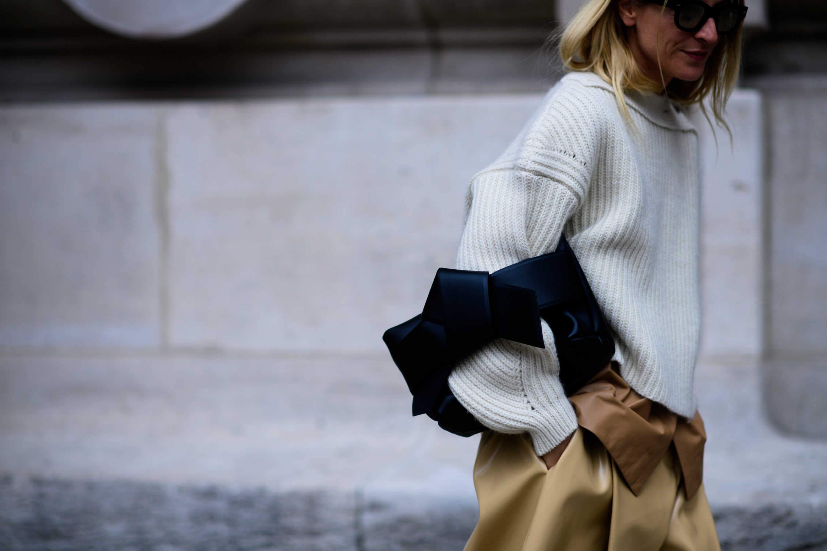 Stylist wearing sunglasses and grey sweater