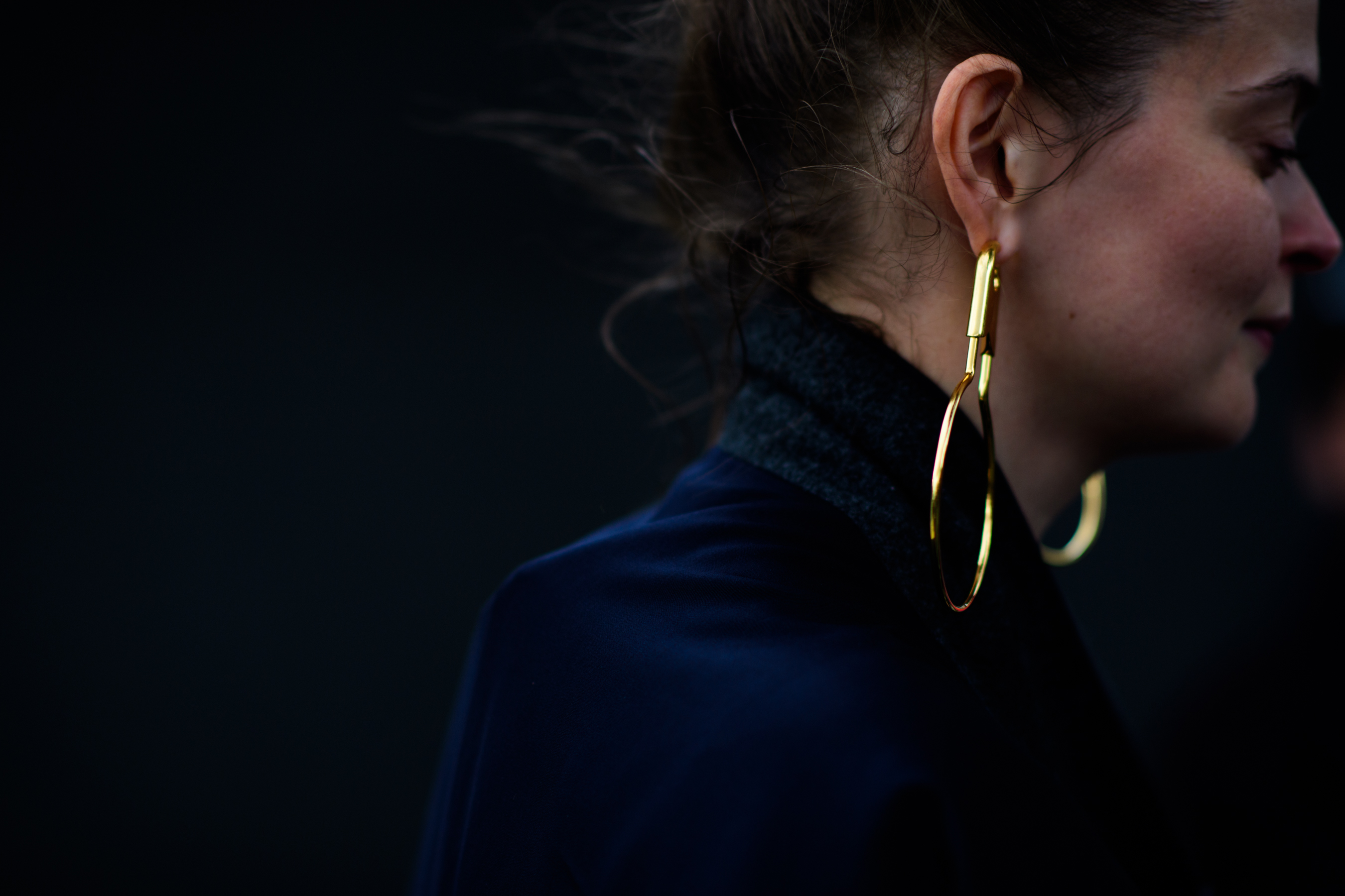 Close up of a woman with large gold earring