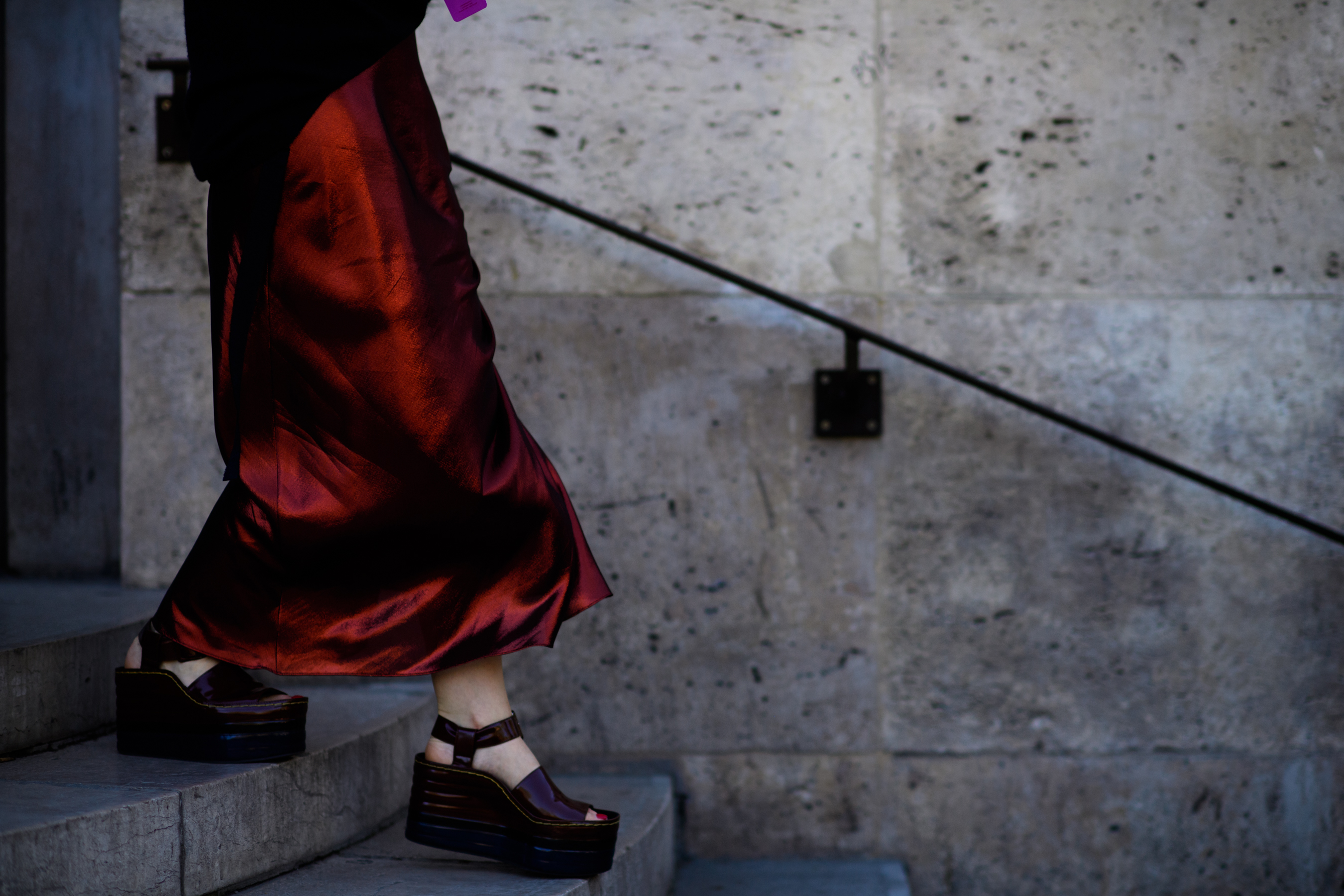 Closeup of womans legs in red dress
