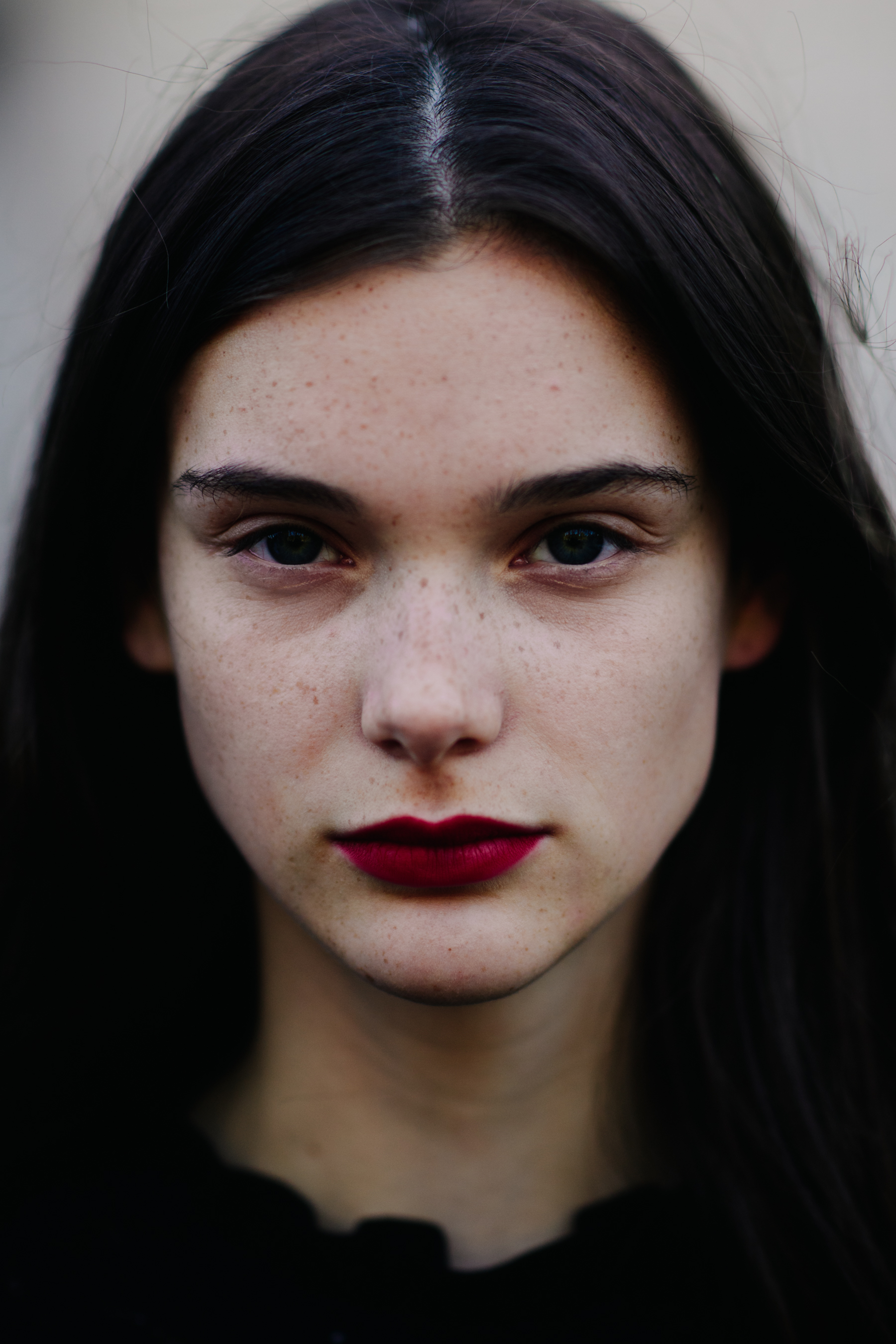 Portrait of model with freckles and red lipstick