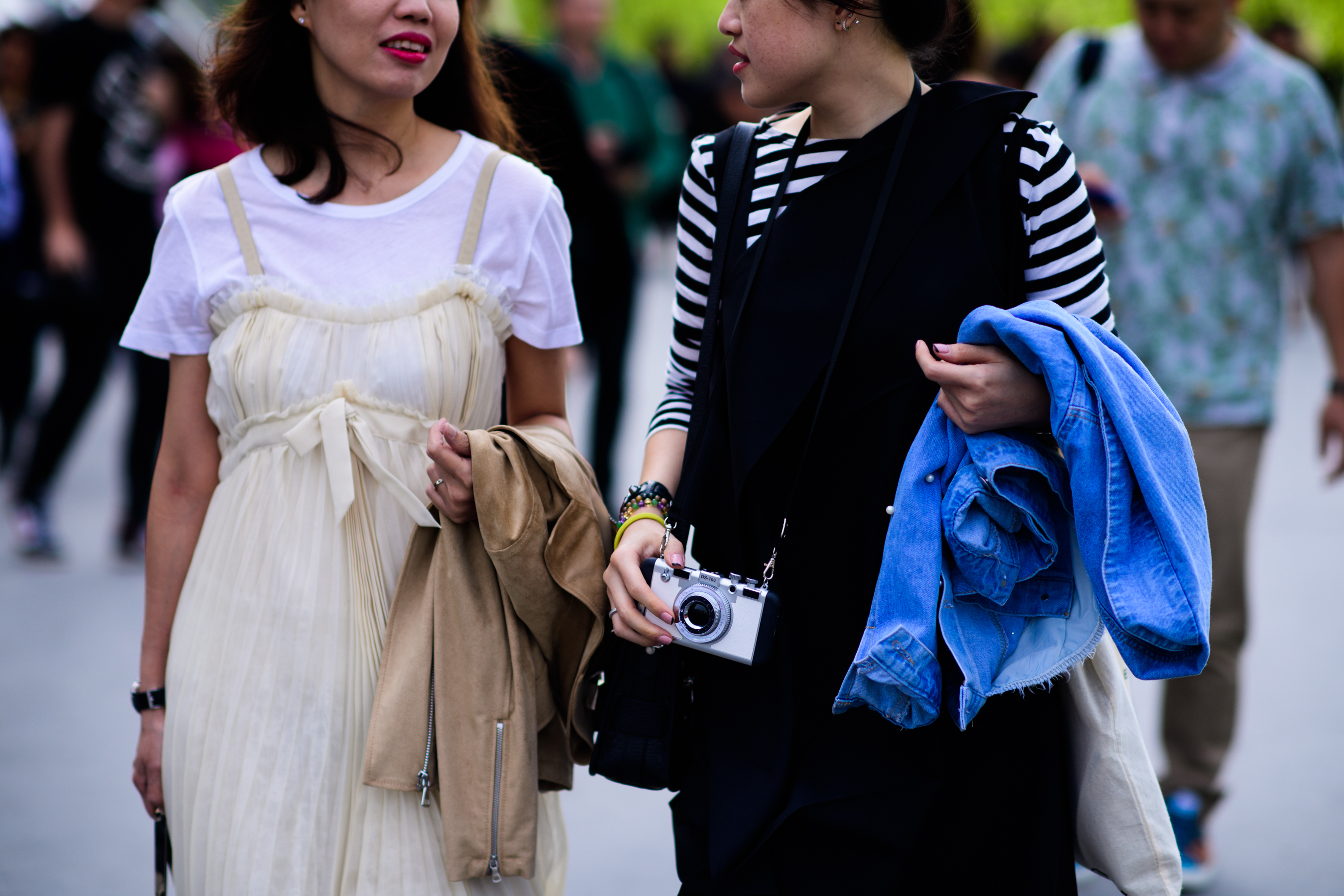Two asian women wearing dresses over tee shirts