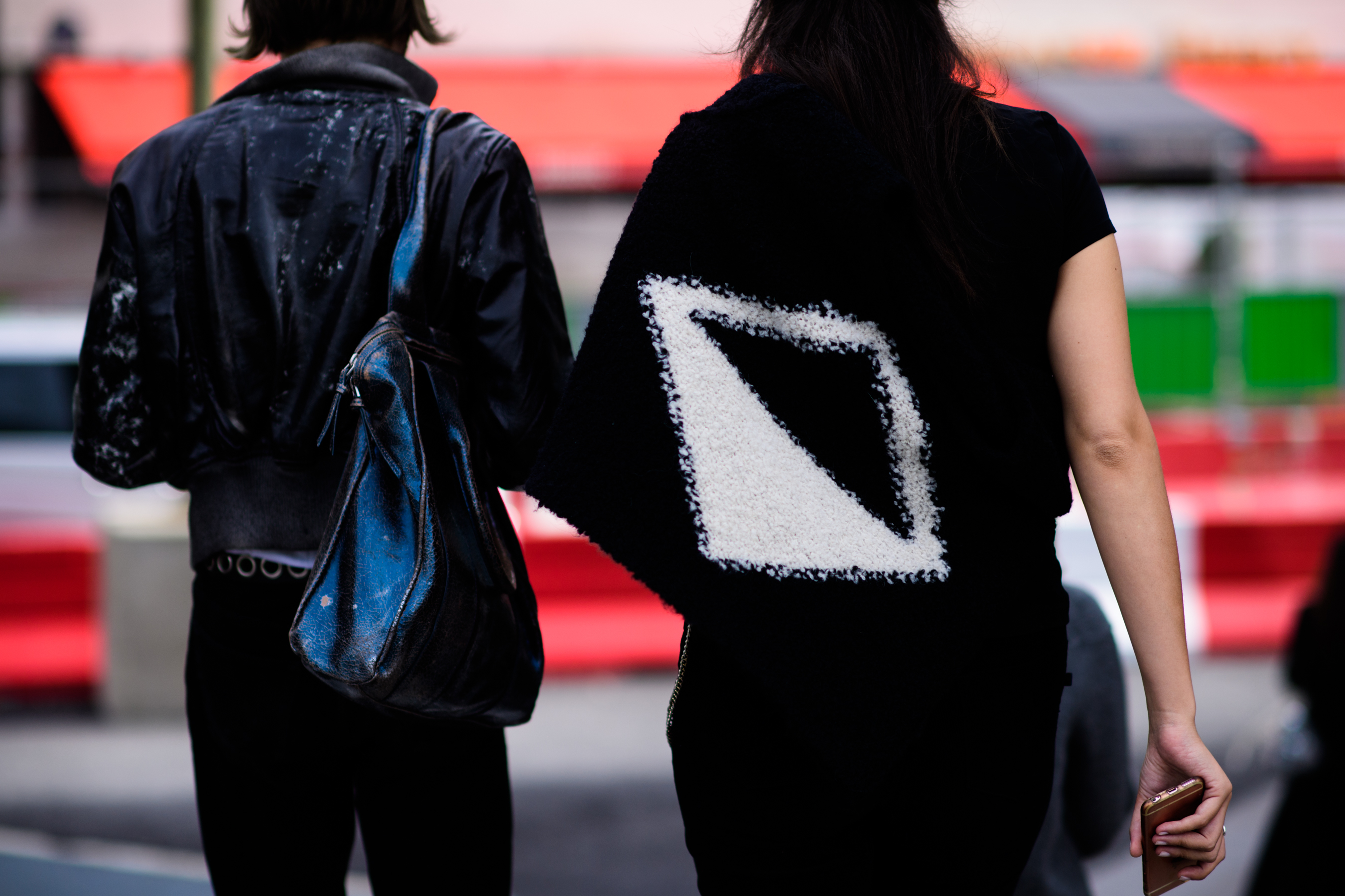 Back of couple wearing black outfits