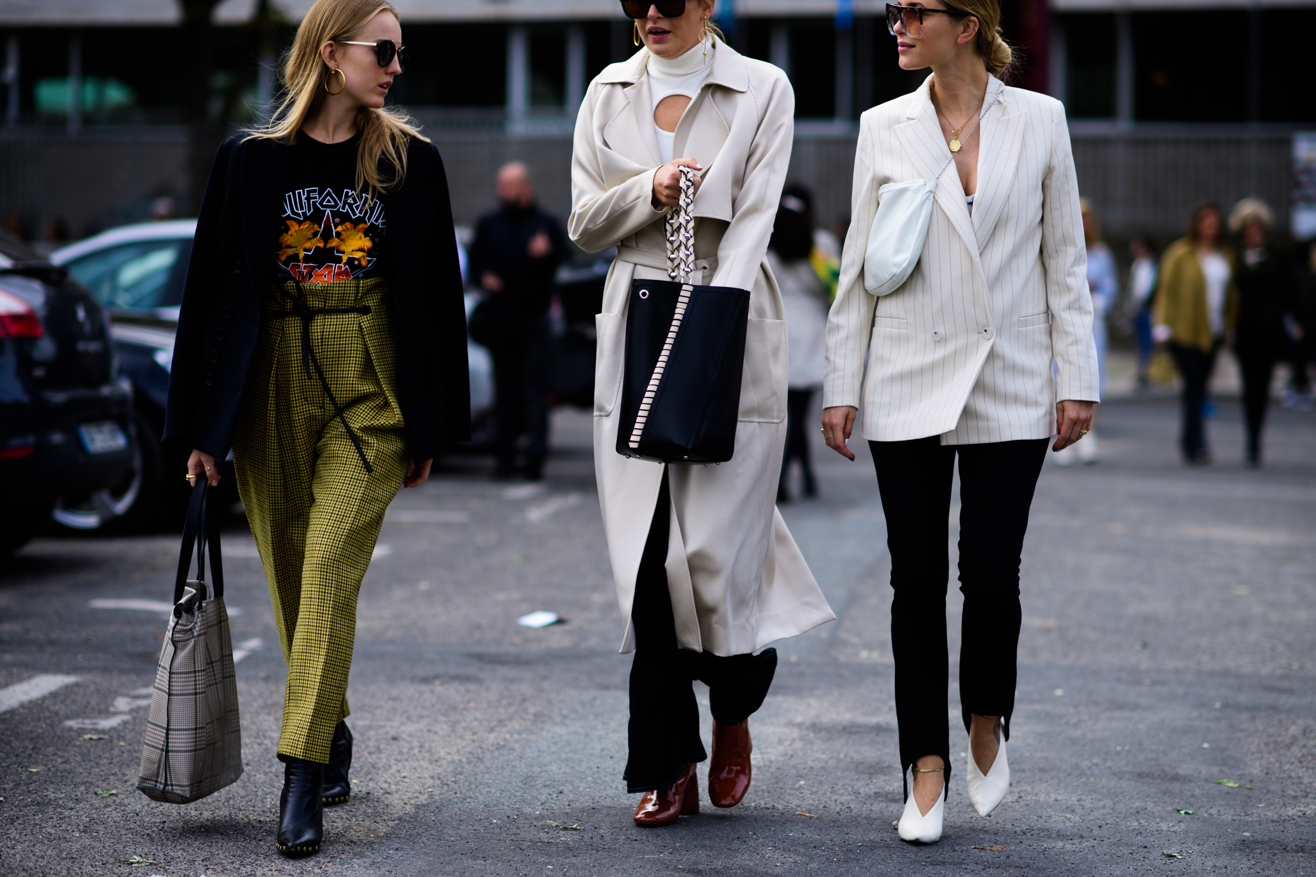 Three women walking wearing formal jackets