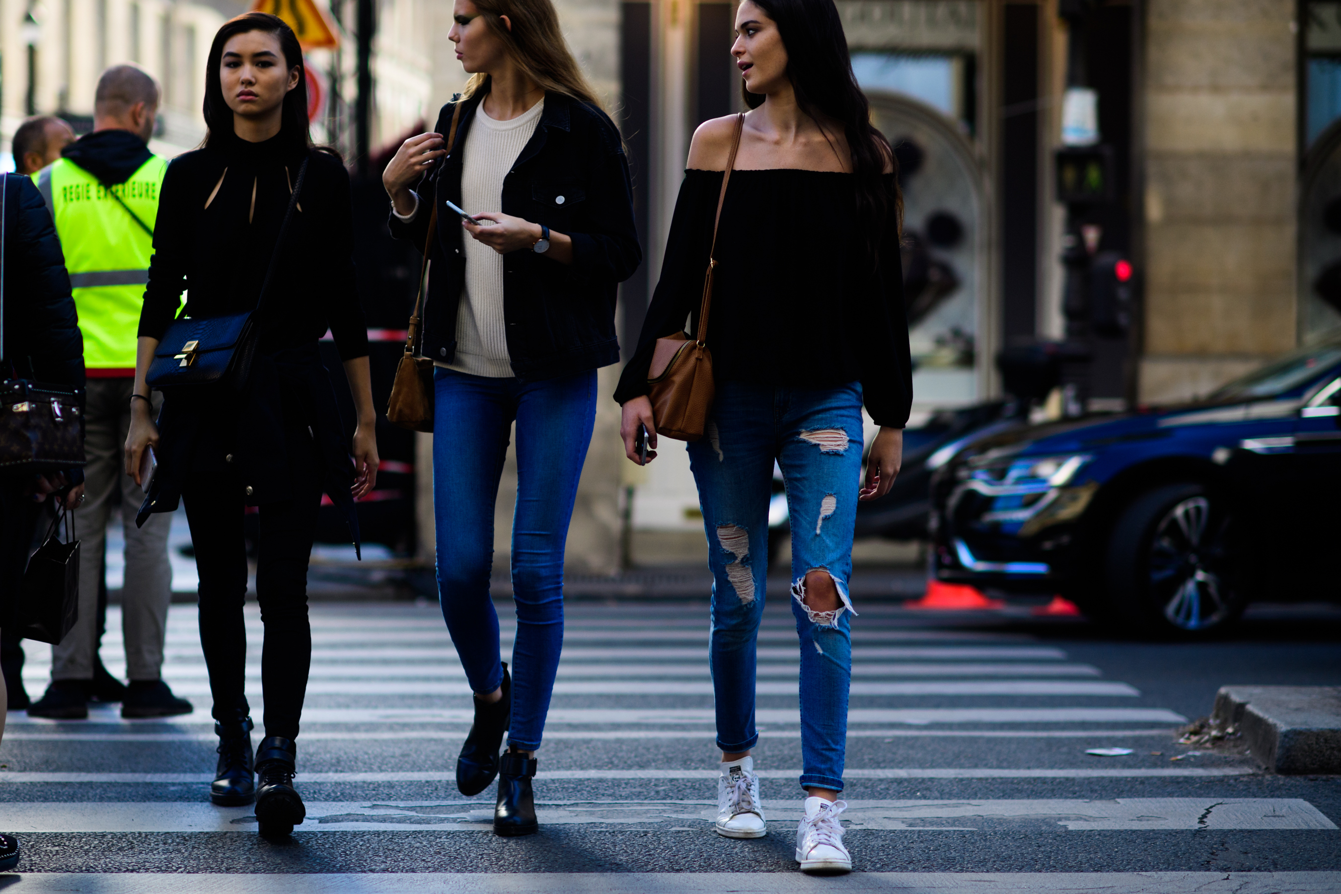 Three models crossing road