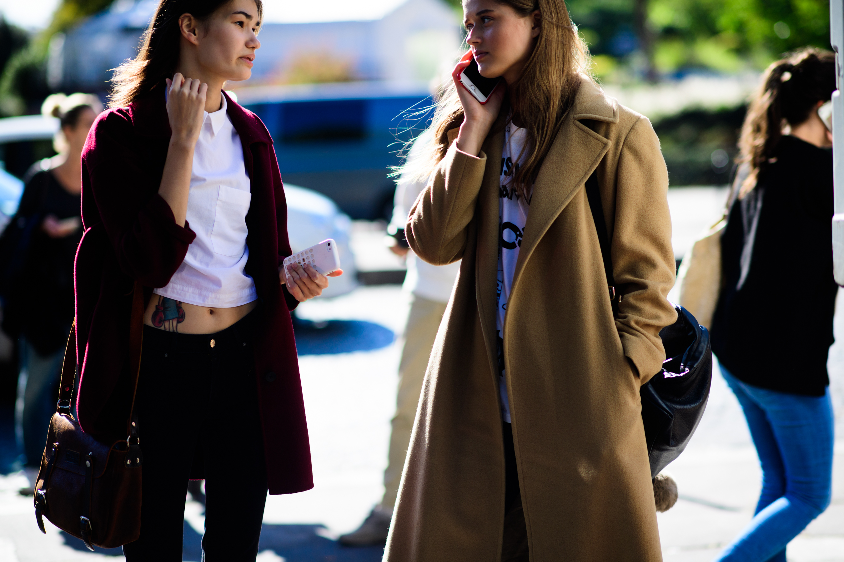 Two models talking in sunlight