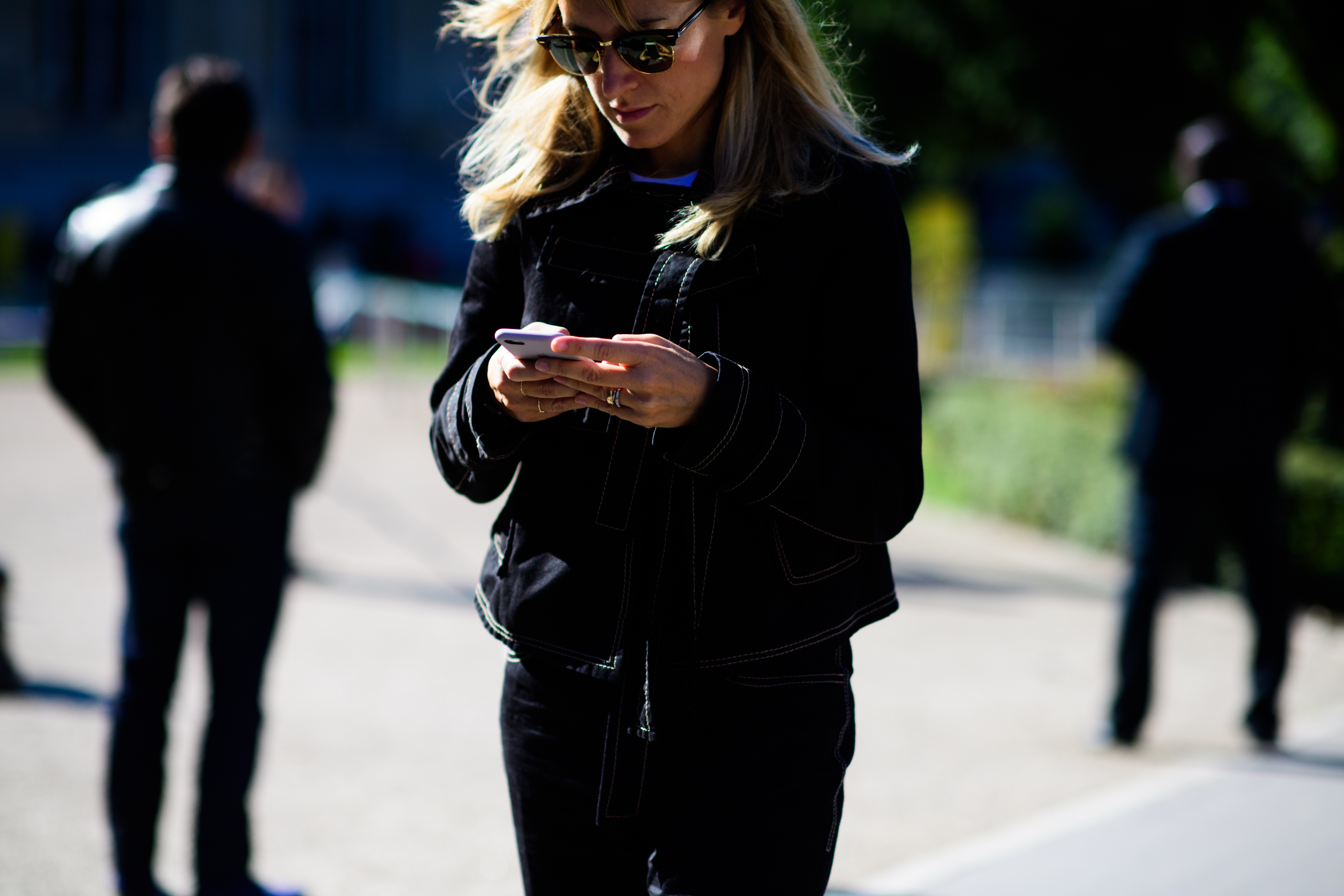 Woman wearing black outfit on phone