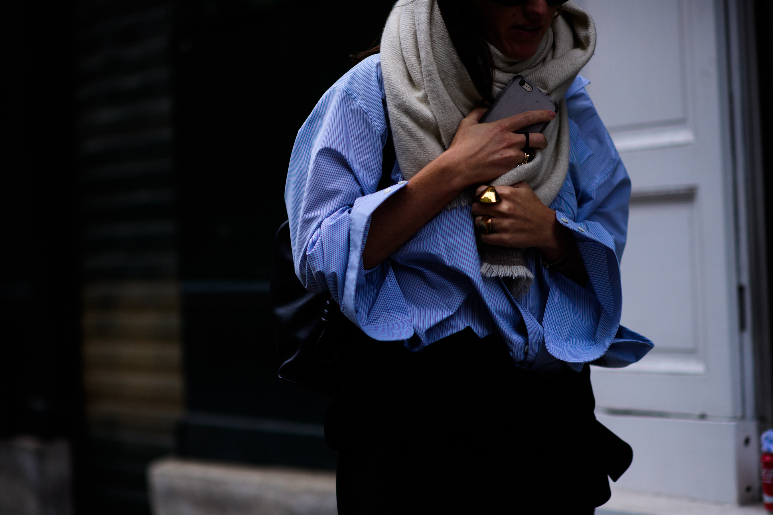 Woman in striped blue shirt holding scarf