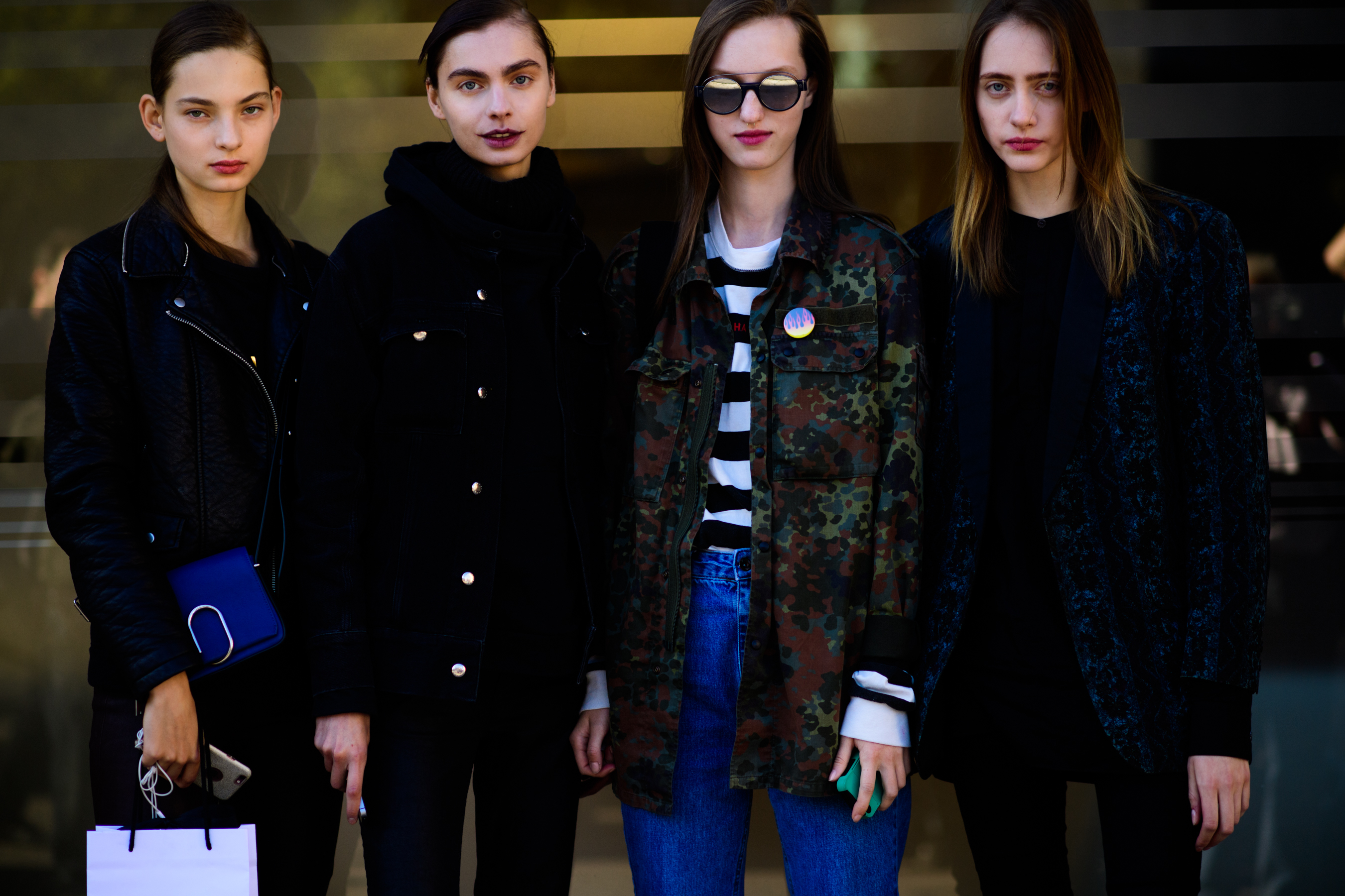 Four models stood against glass window