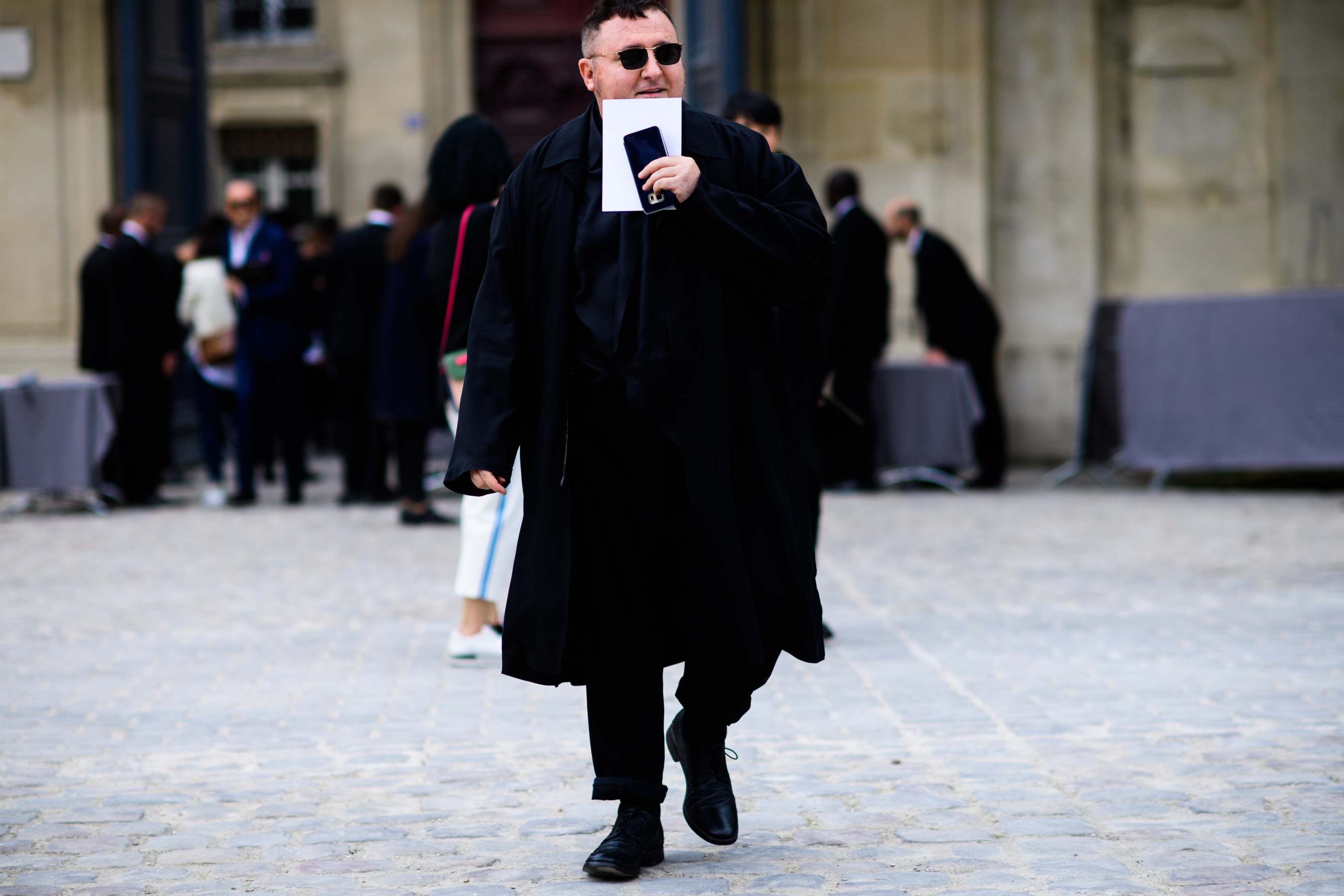 Man wearing black outfit and glasses
