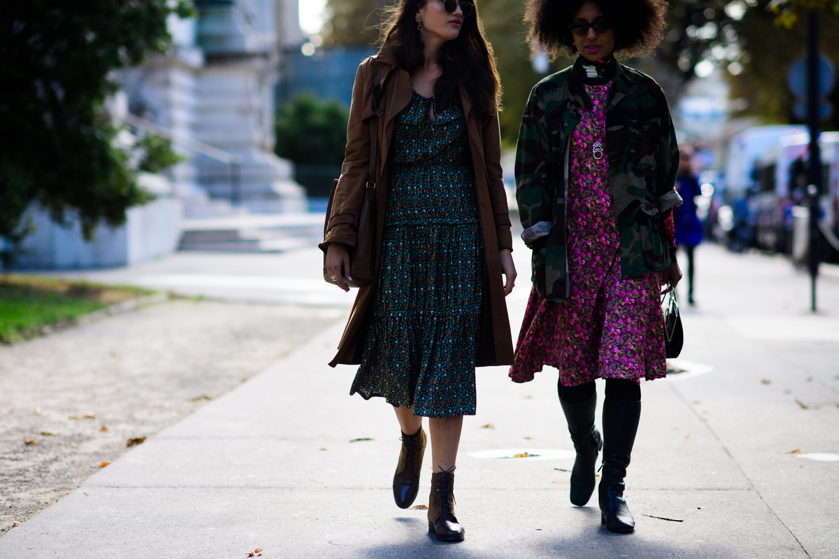 Two women wearing patterned dresses