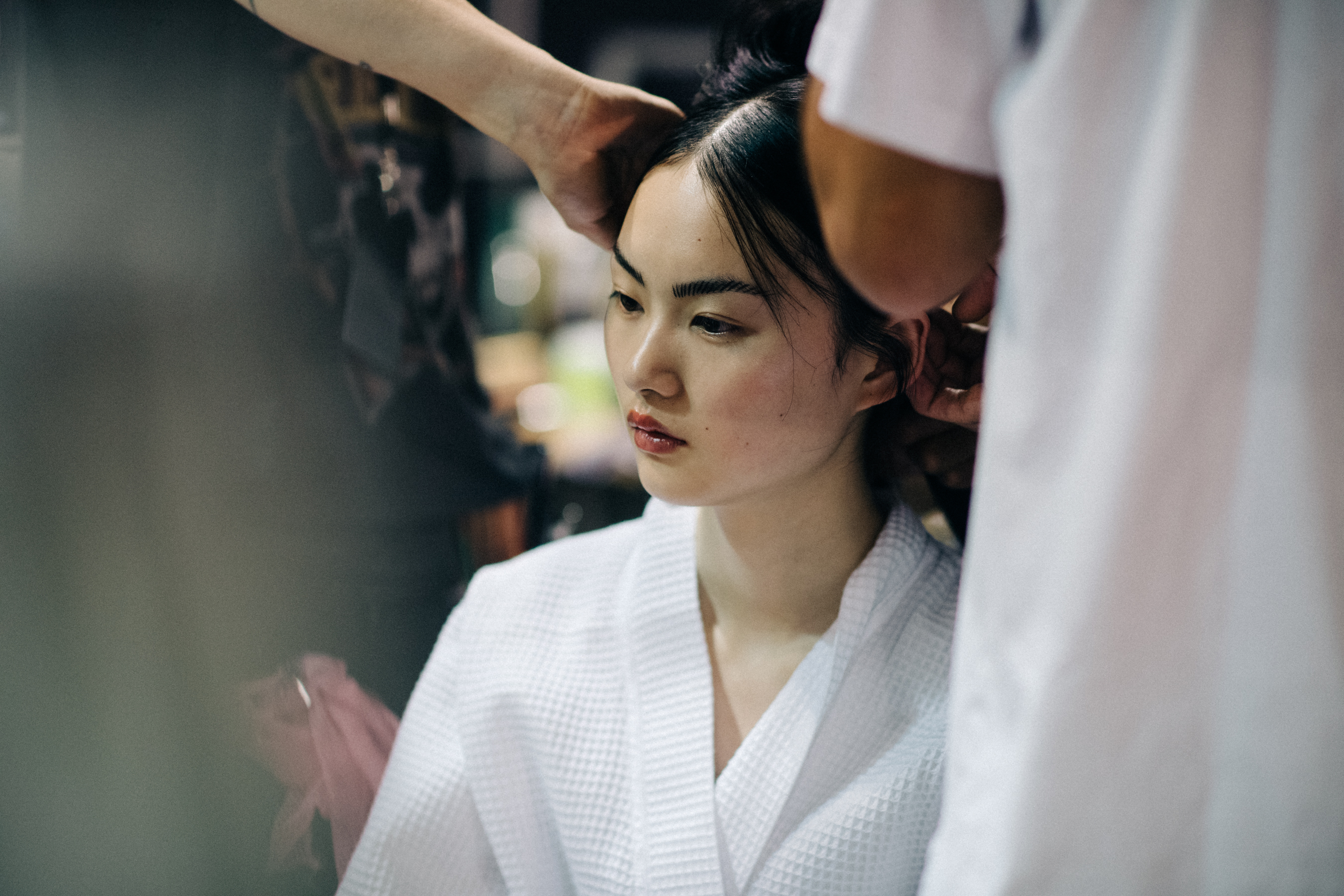Model Cong He getting make up done