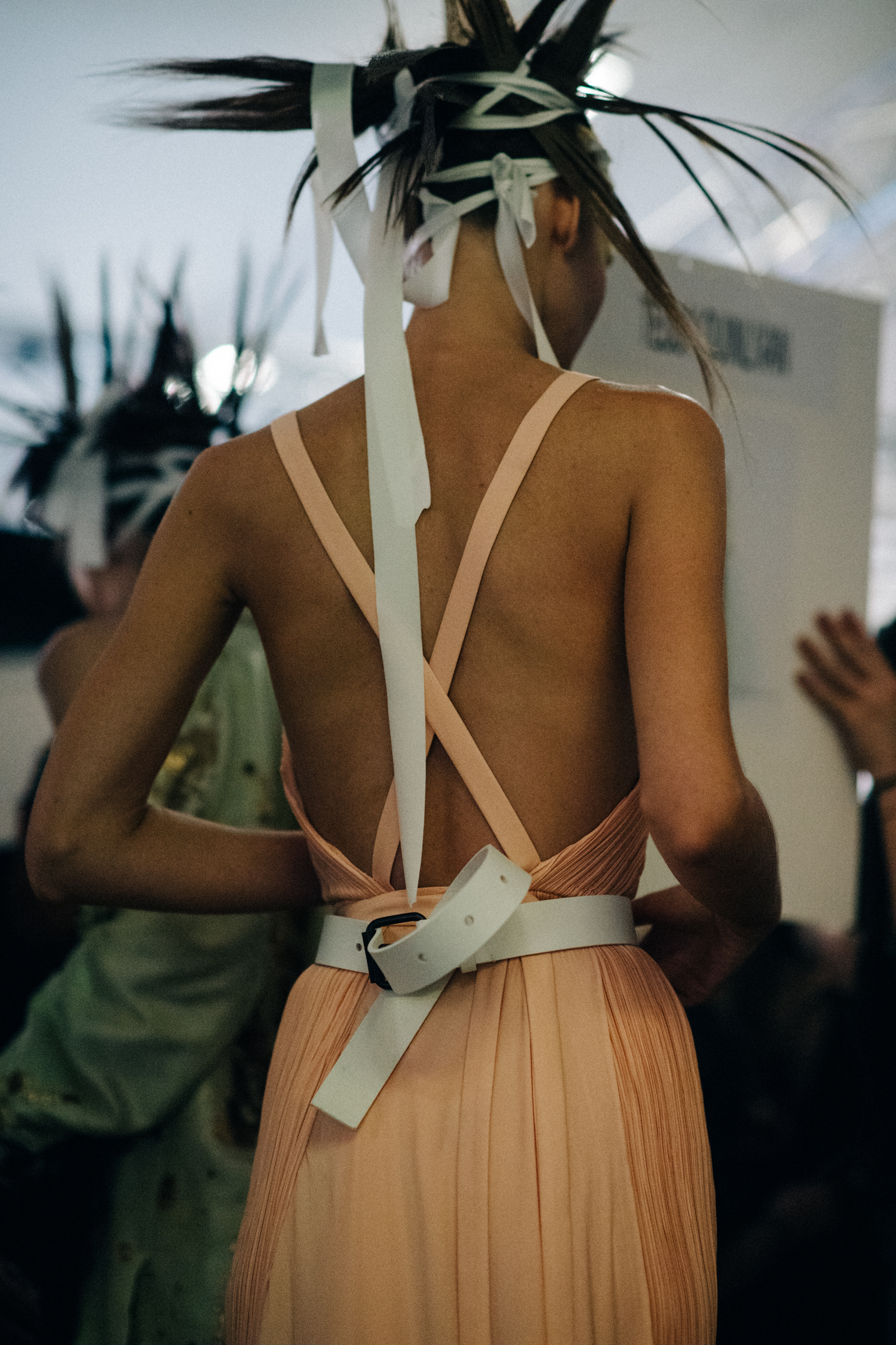 Model wearing peach strap dress