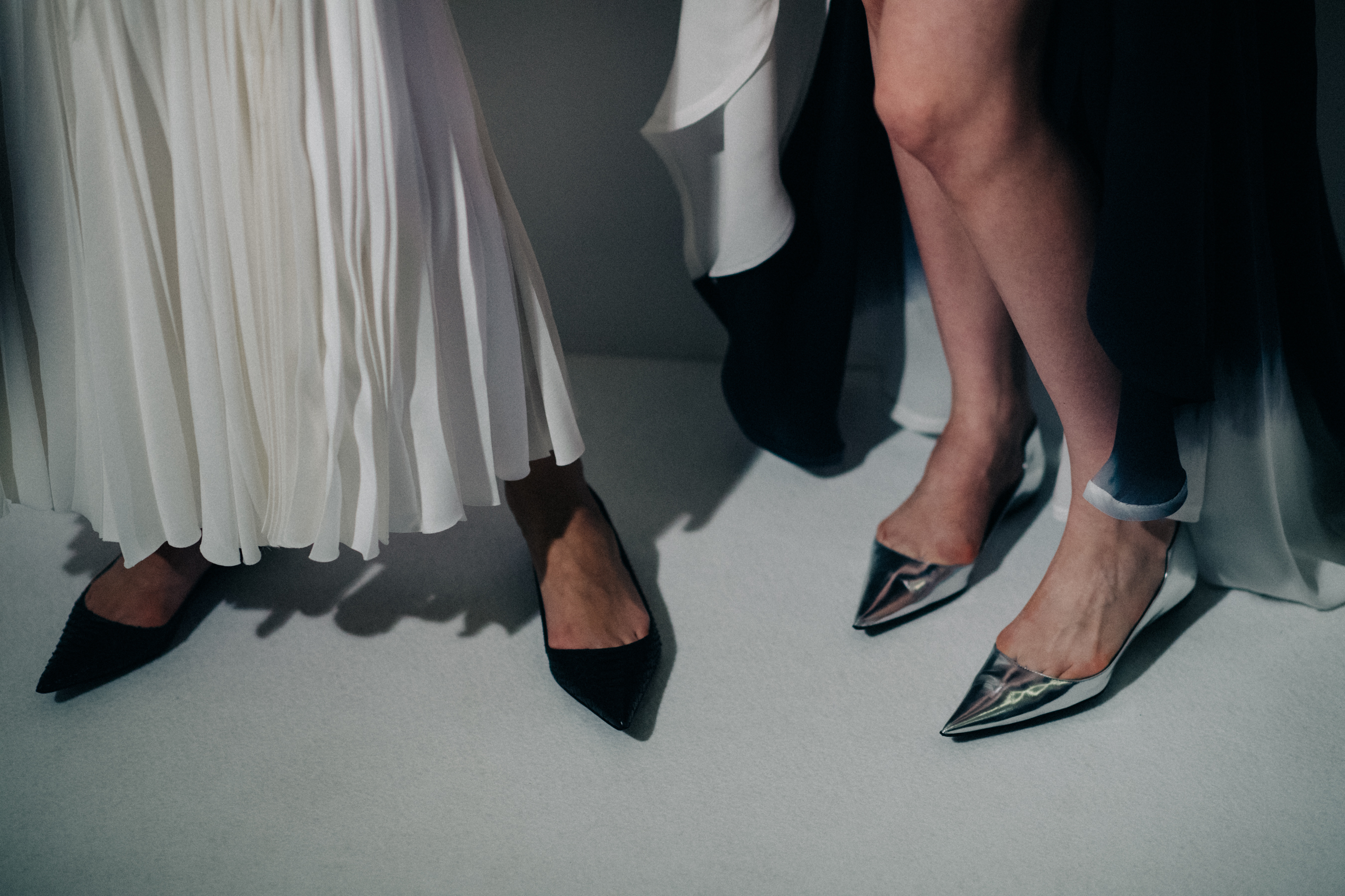 Two models wearing pointed toe shoes