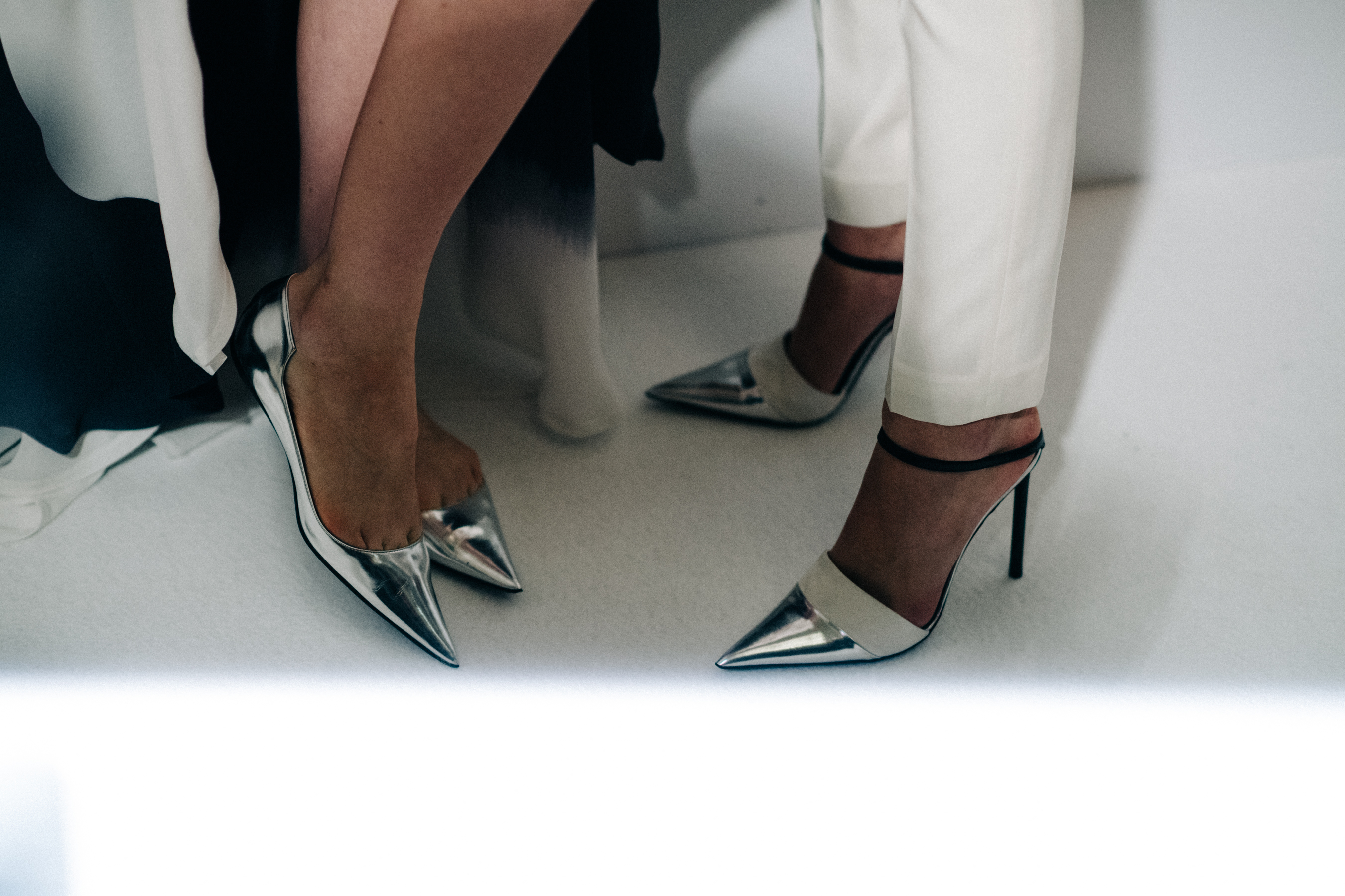 Models wearing shoes with pointy toes