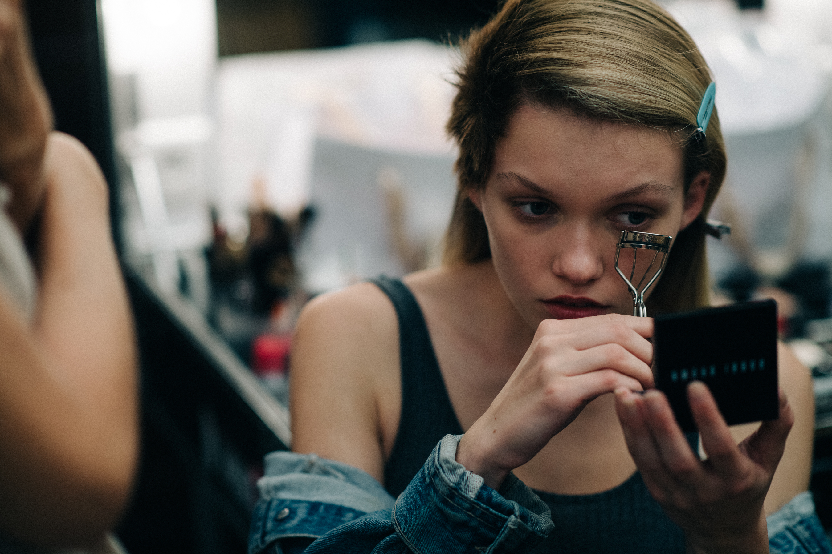 Model getting her lashes curled
