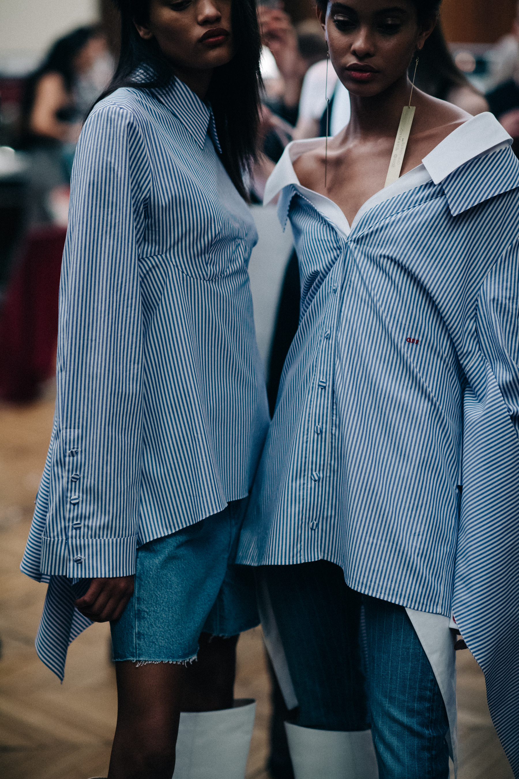 Two models wearing oversized shirts