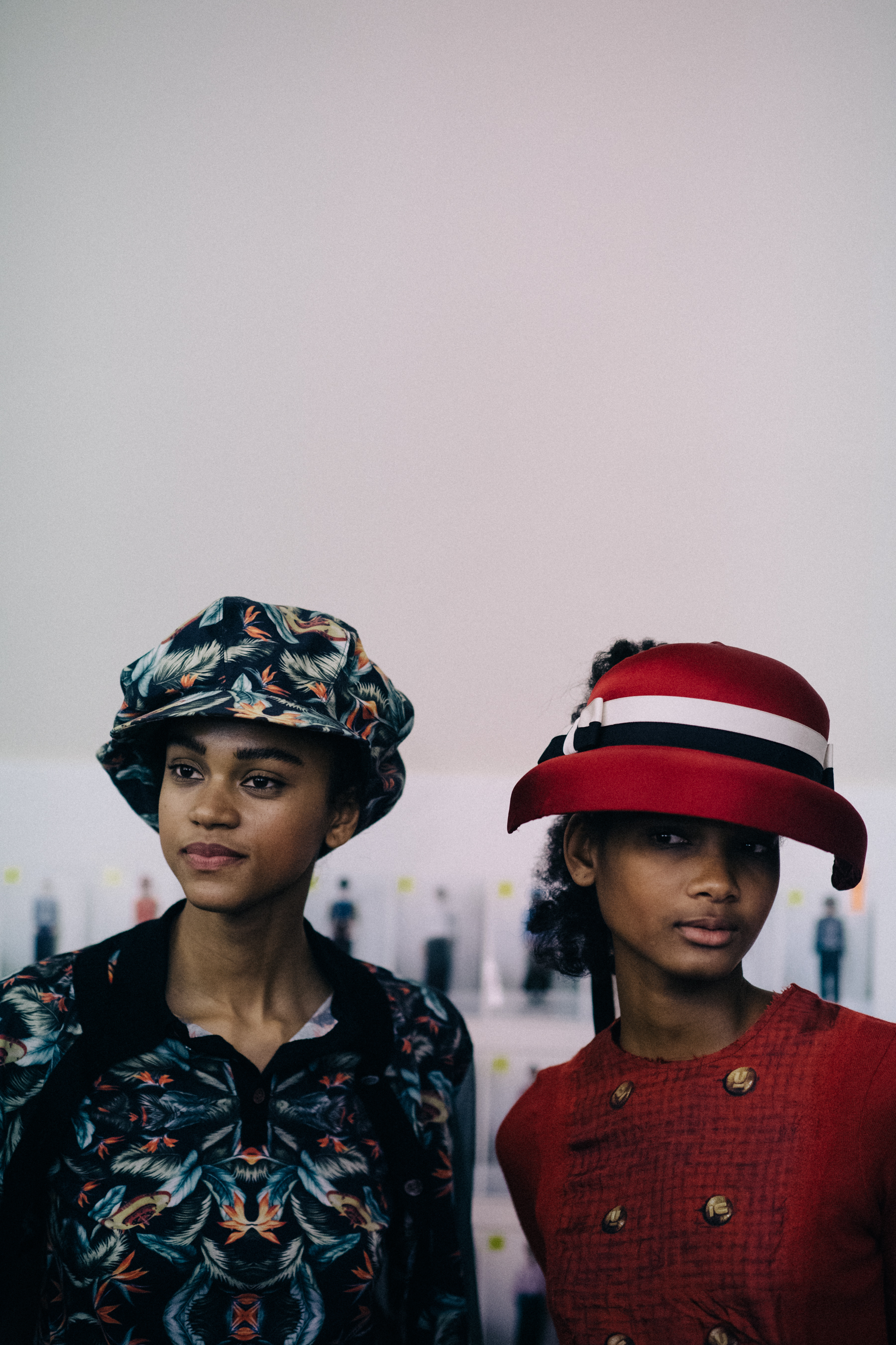 Models wering vintage style hats