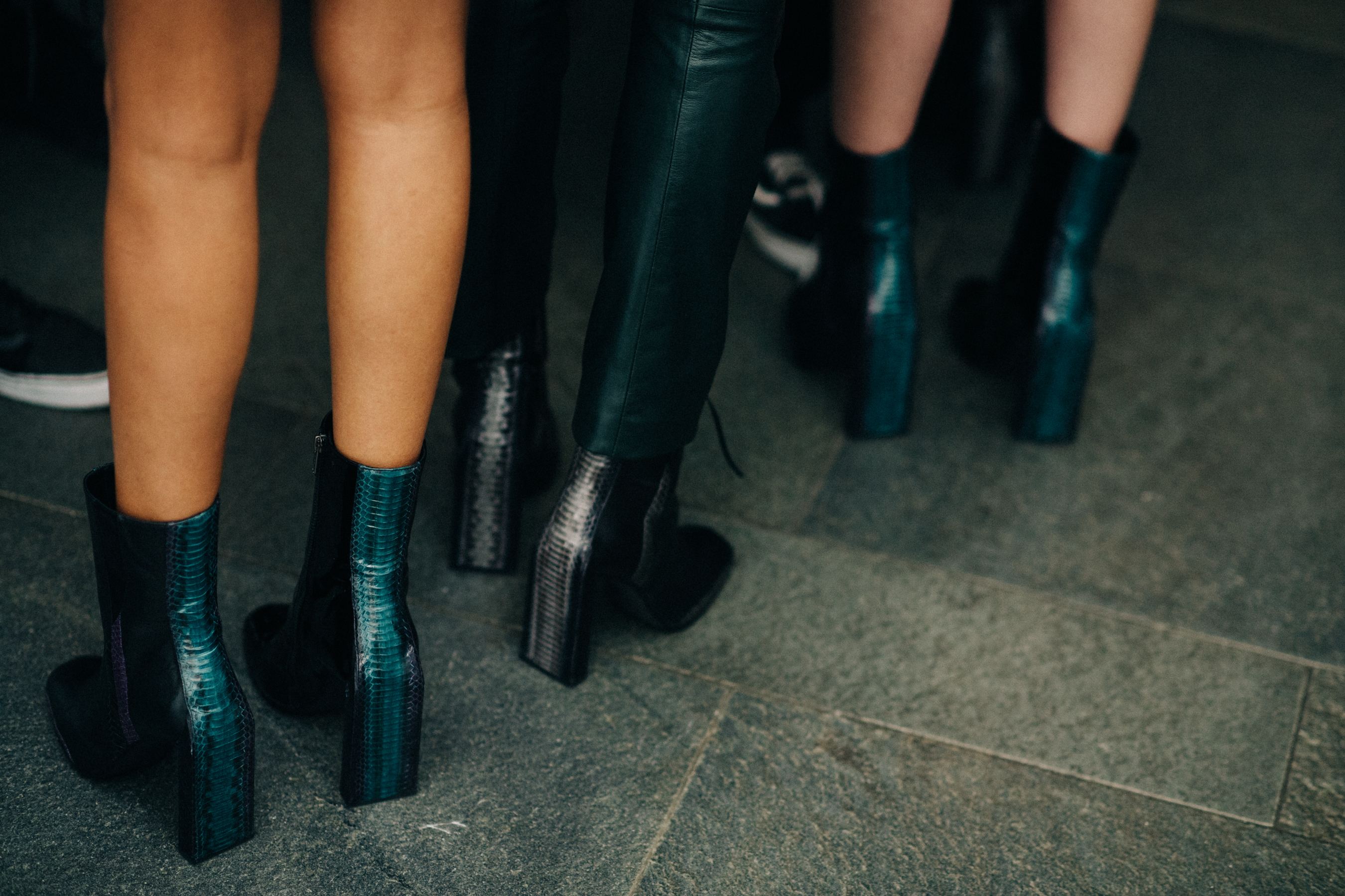Two women wearing high heel boots