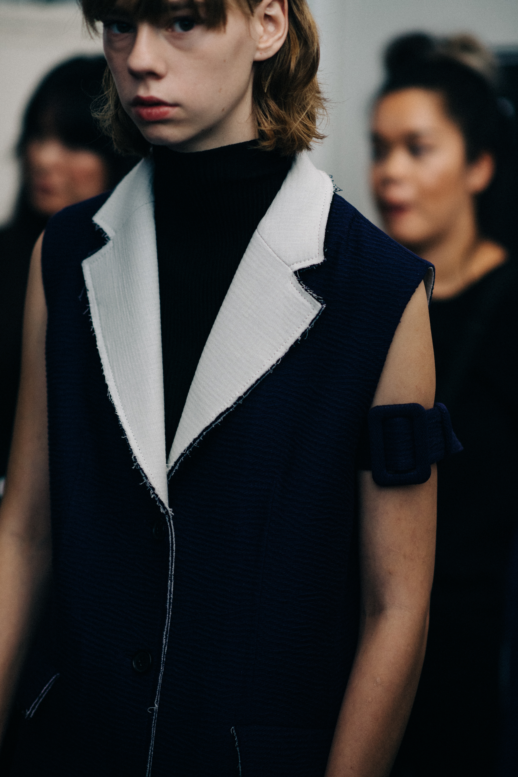 Model wearing dark clothing before the show