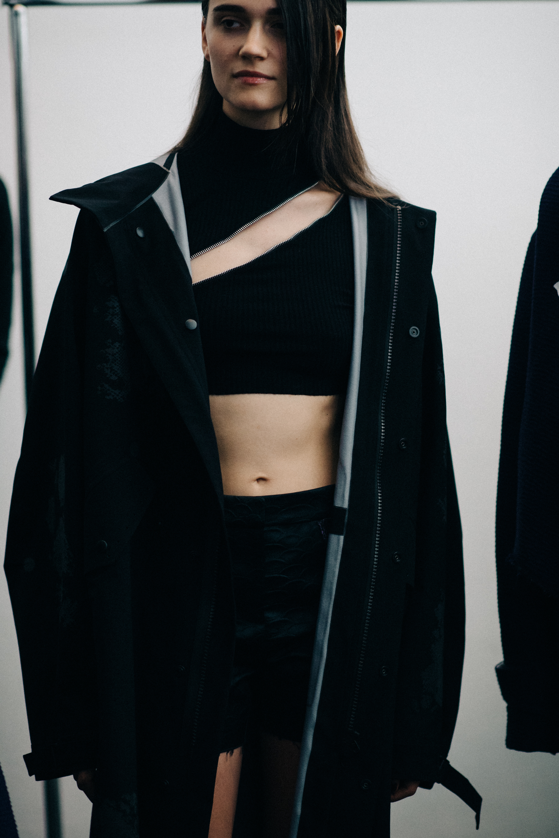 Model wearing dark clothing before the show