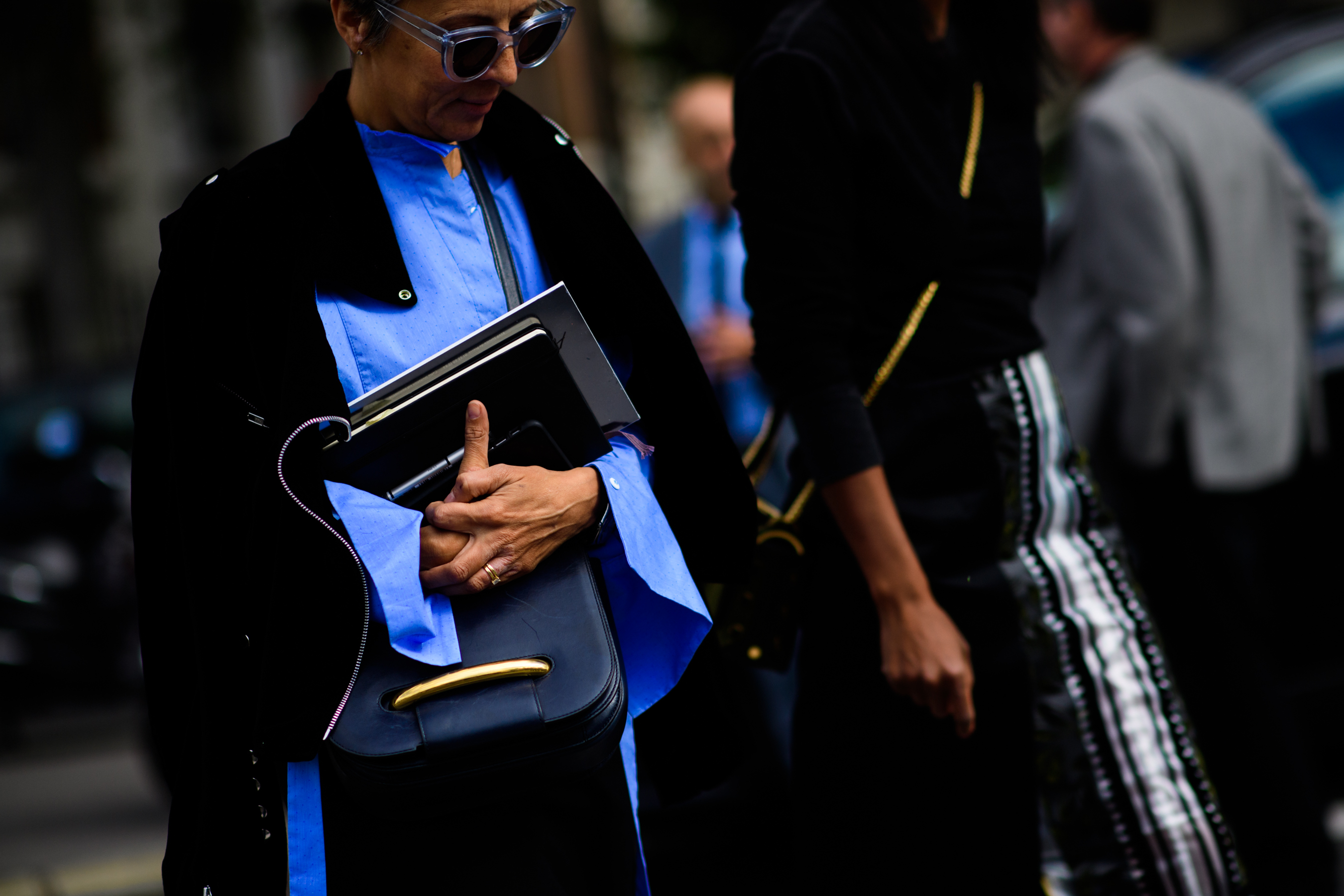 Woman in blue shirt holding books