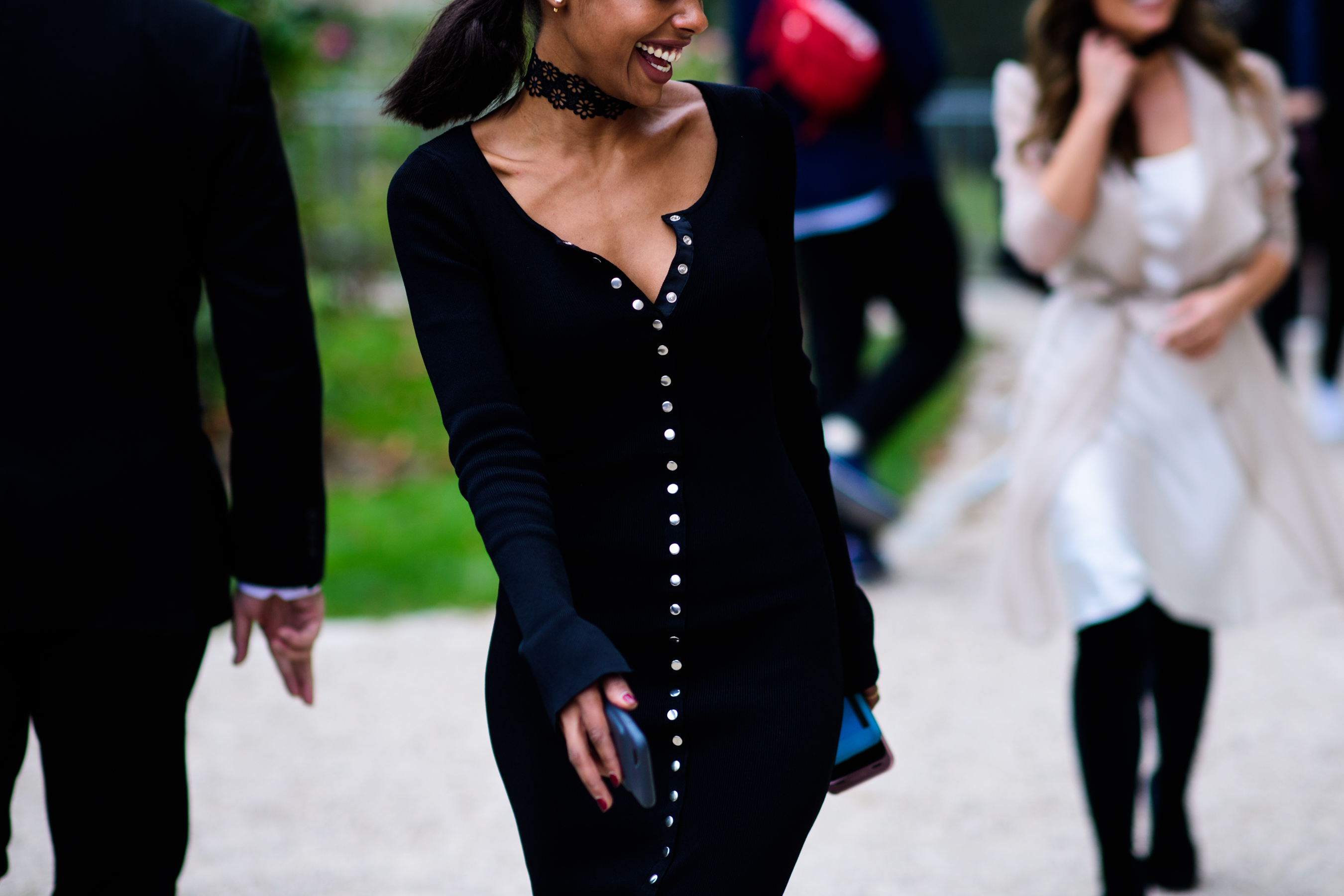 Woman laughing wearing black and silver button dress
