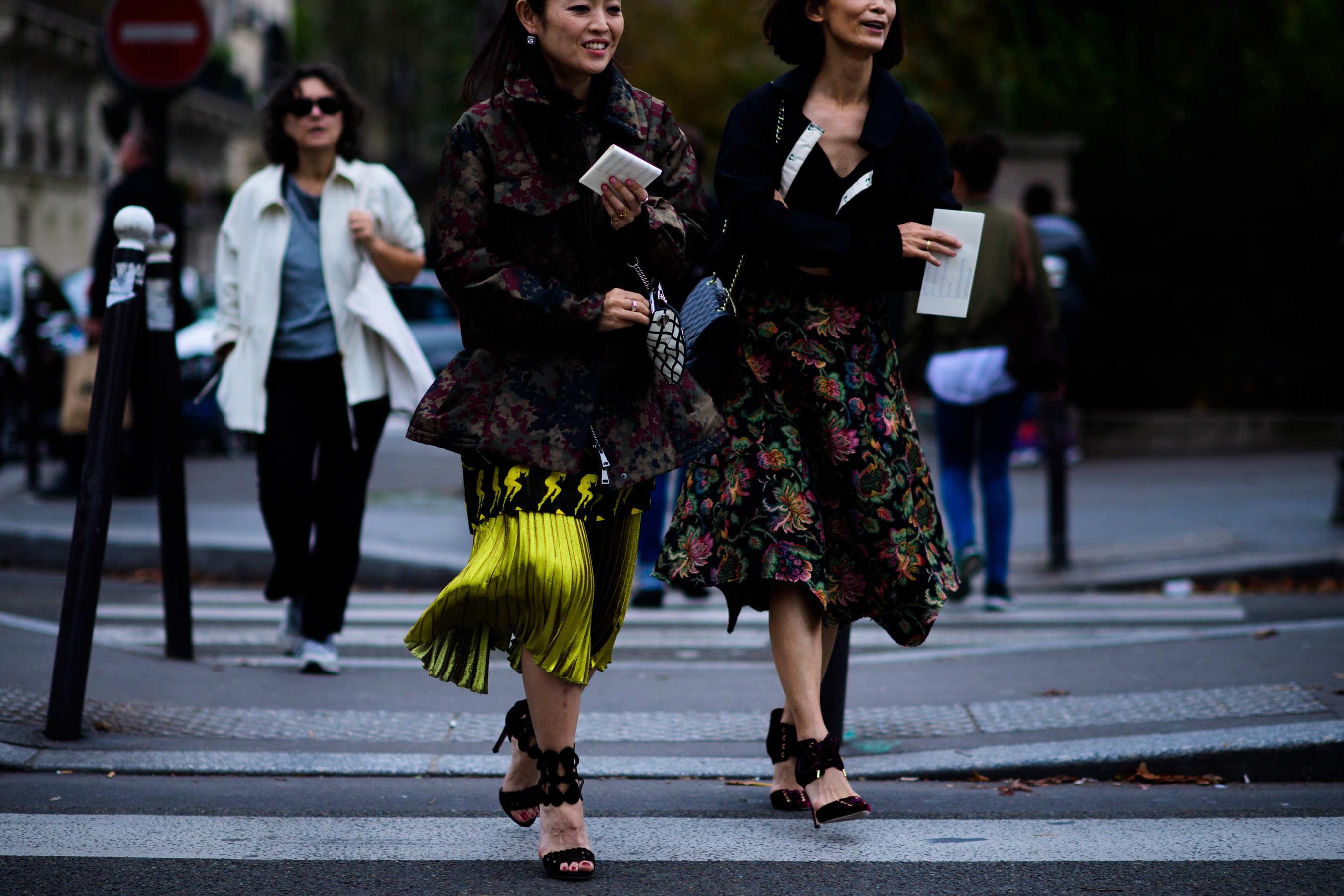 Two women crossing road before Comme des Garçons show