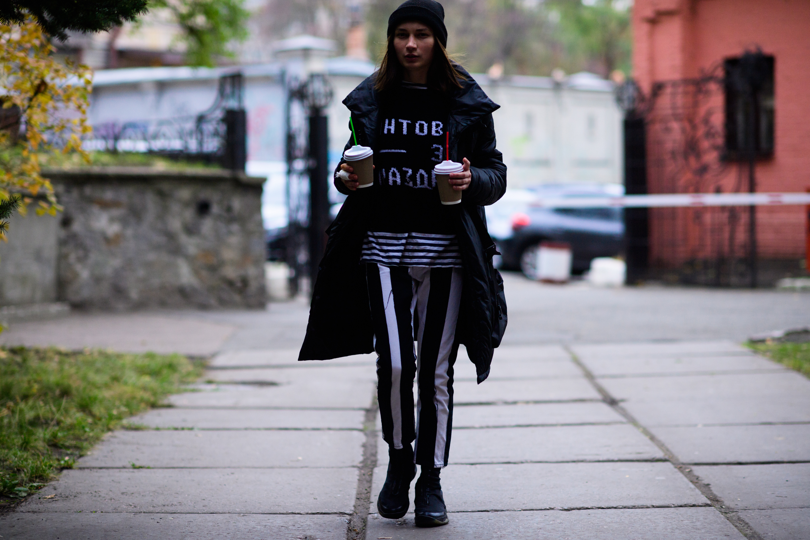 Girl carrying two coffee cups
